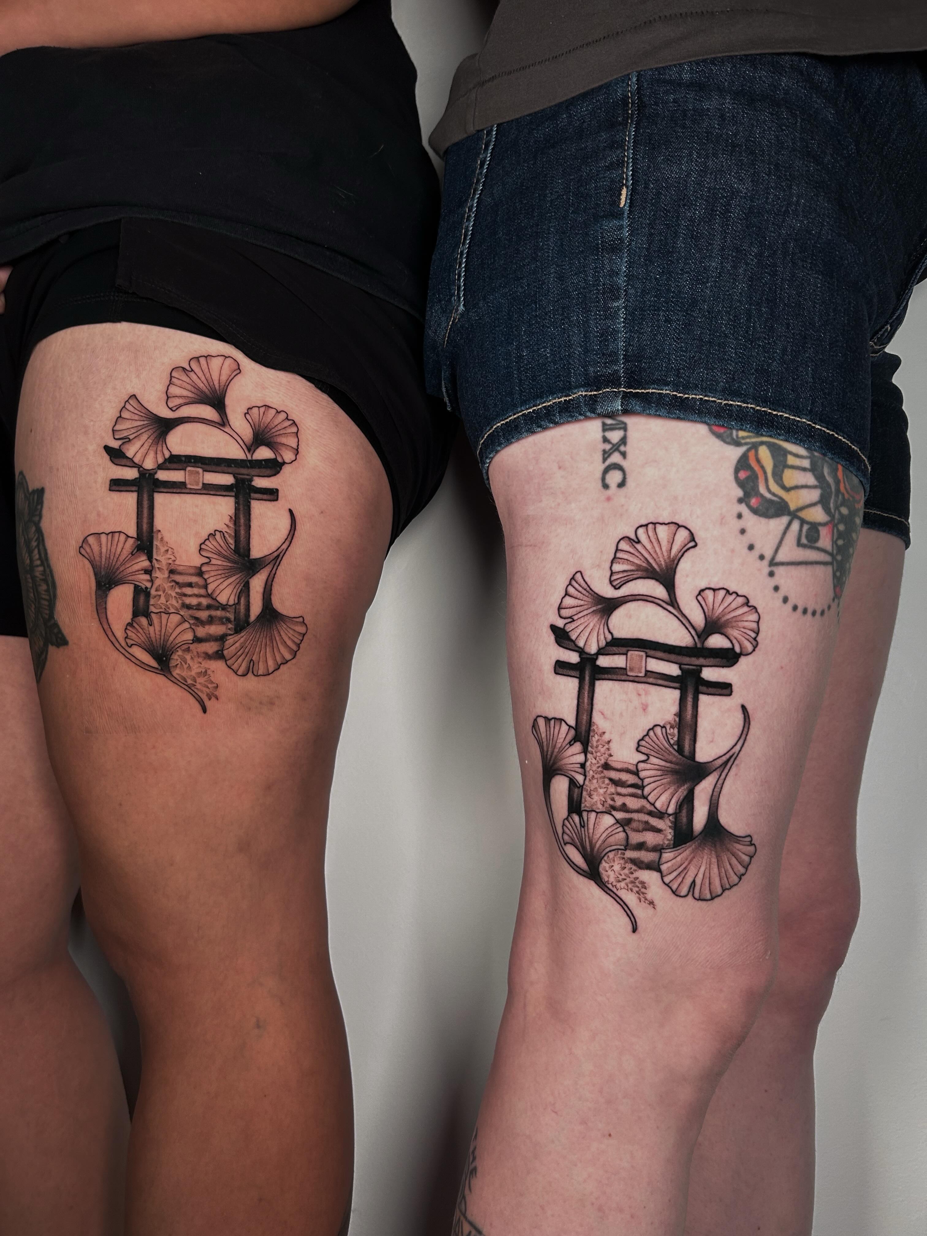 Torii gate and ginkgo leaves black and grey tattoo on the thigh by Salt Lake City tattoo artist