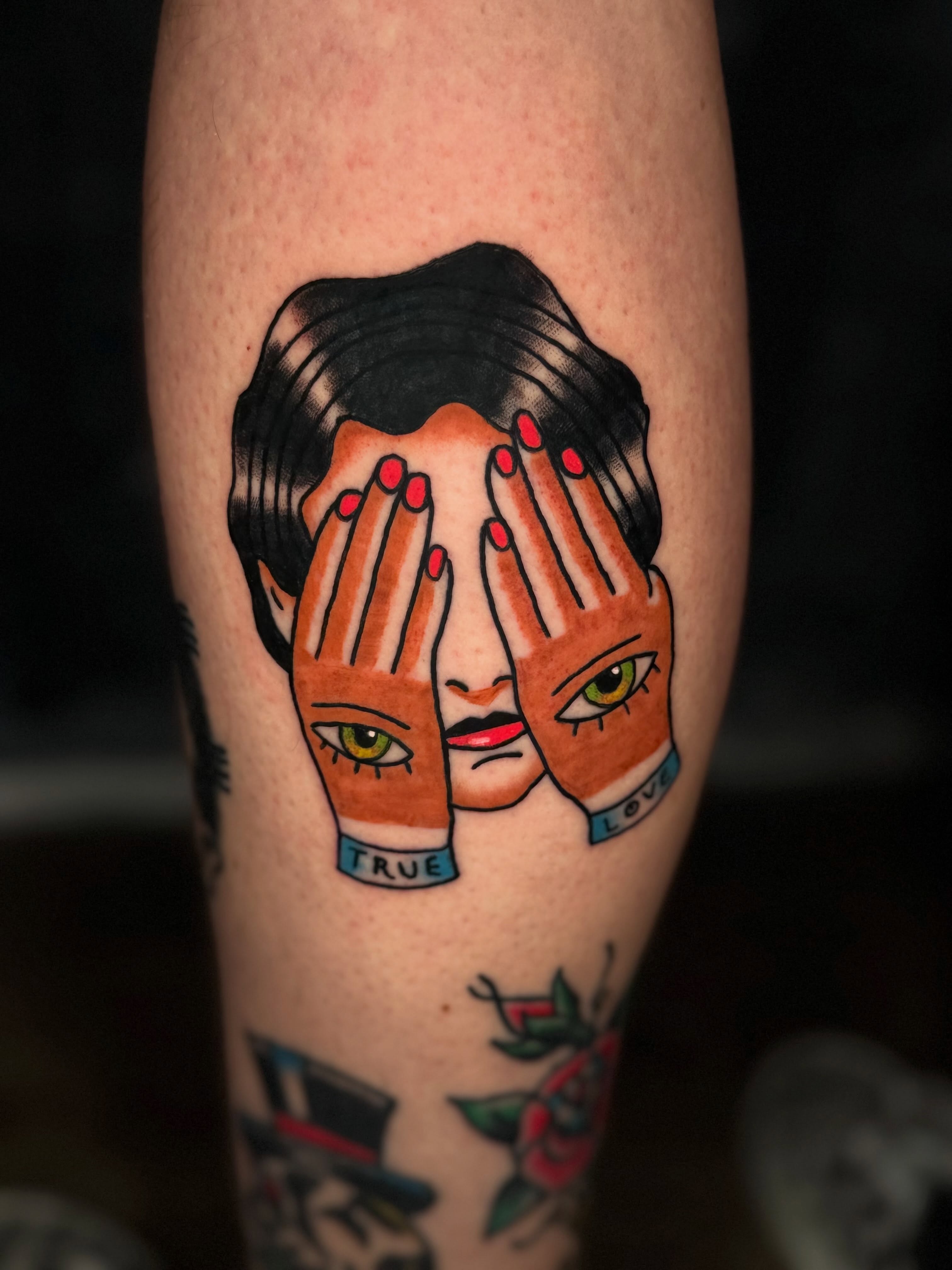 Hands covering face American traditional tattoo on the forearm by Camilo