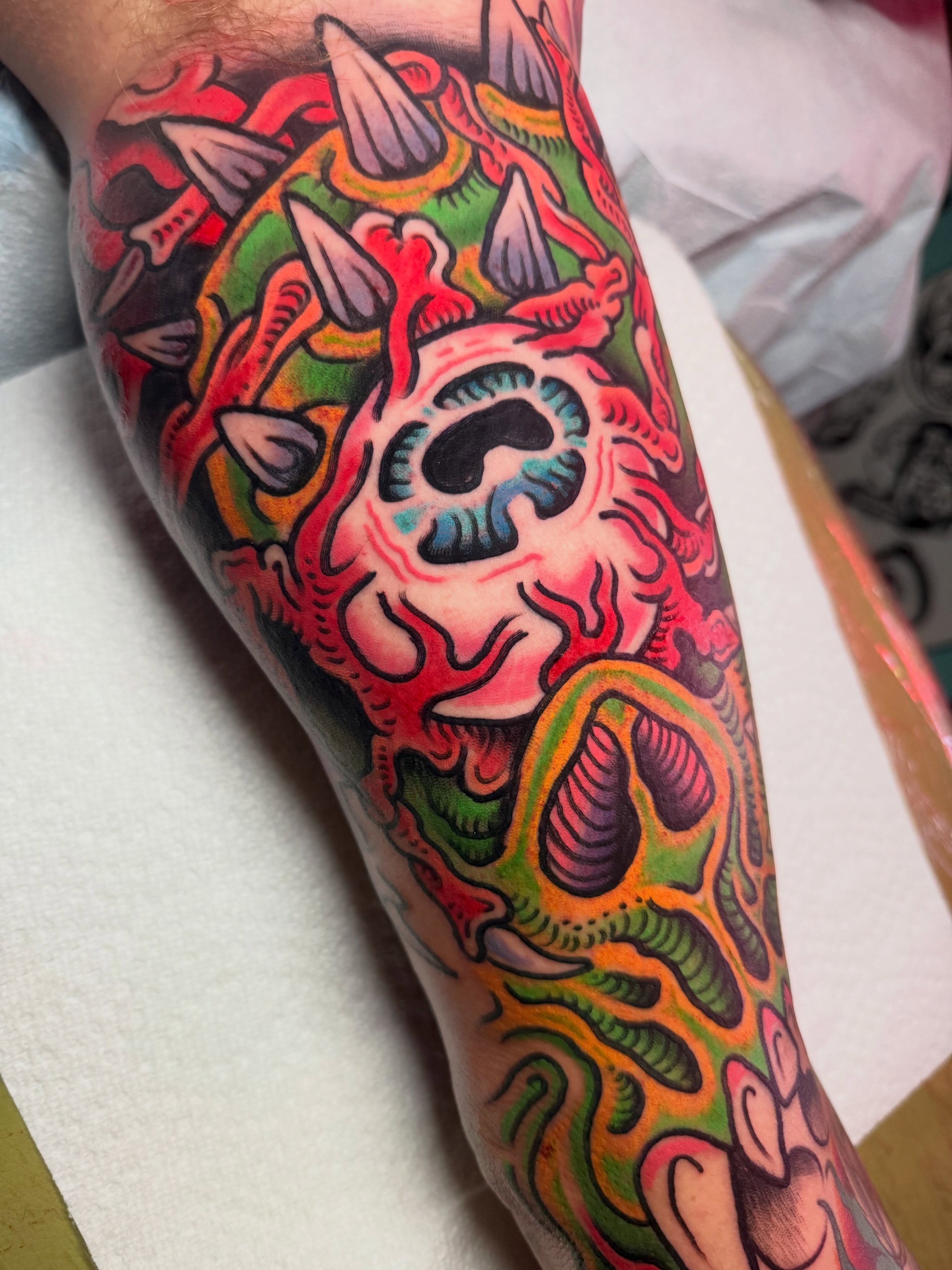 Abstract creature American traditional tattoo on the forearm by Chris Bishop