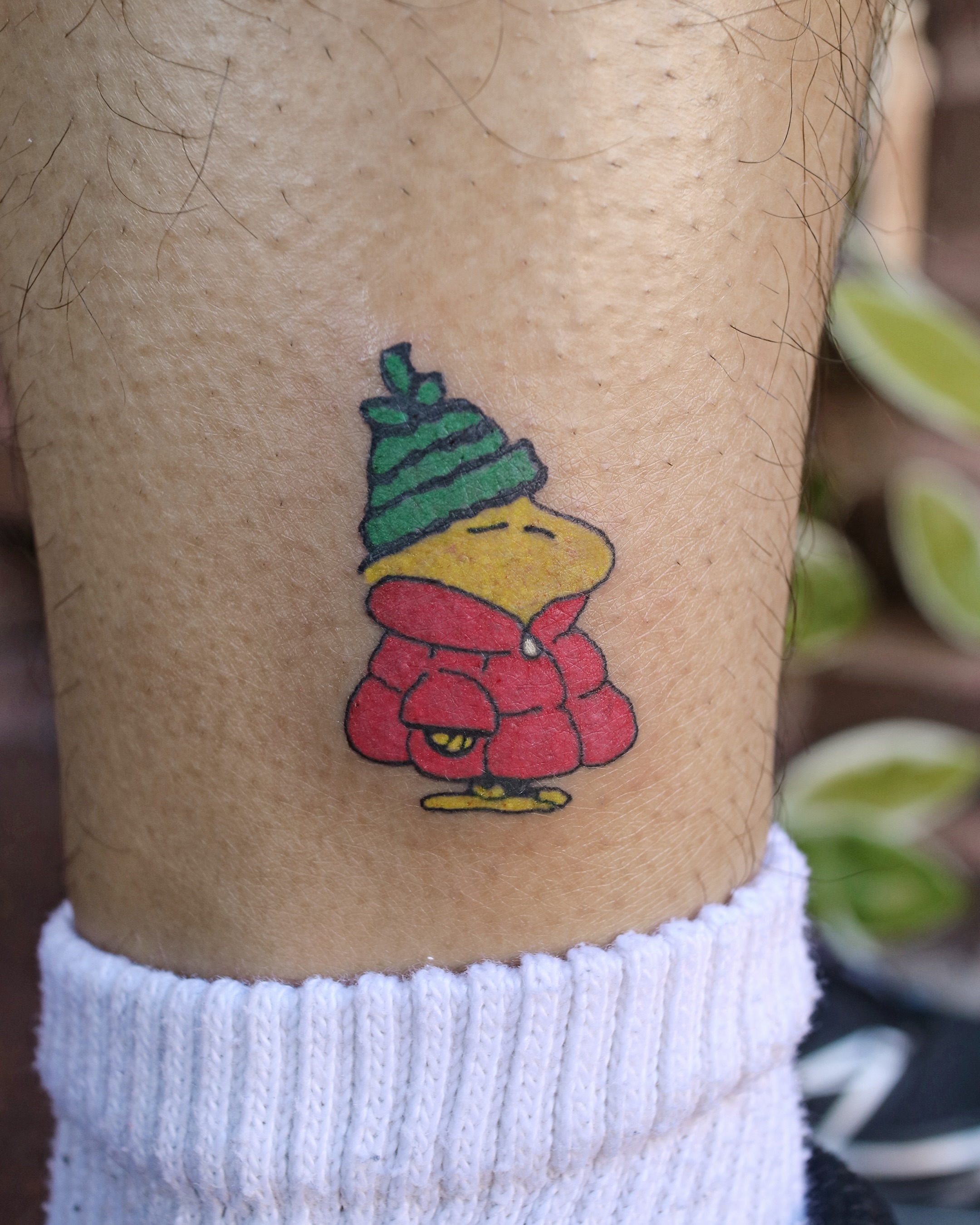 Peanuts character dotwork tattoo on the forearm by Aroha