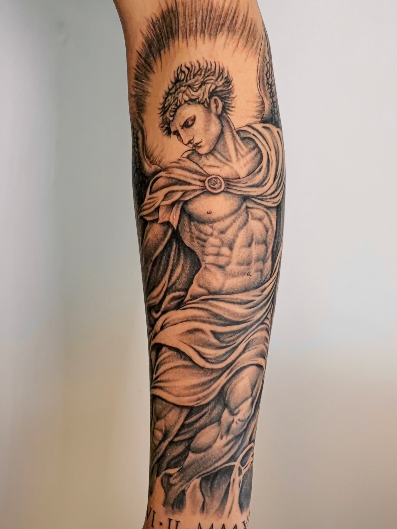 Statue of jesus black and grey tattoo on the forearm by Angel Tattoos