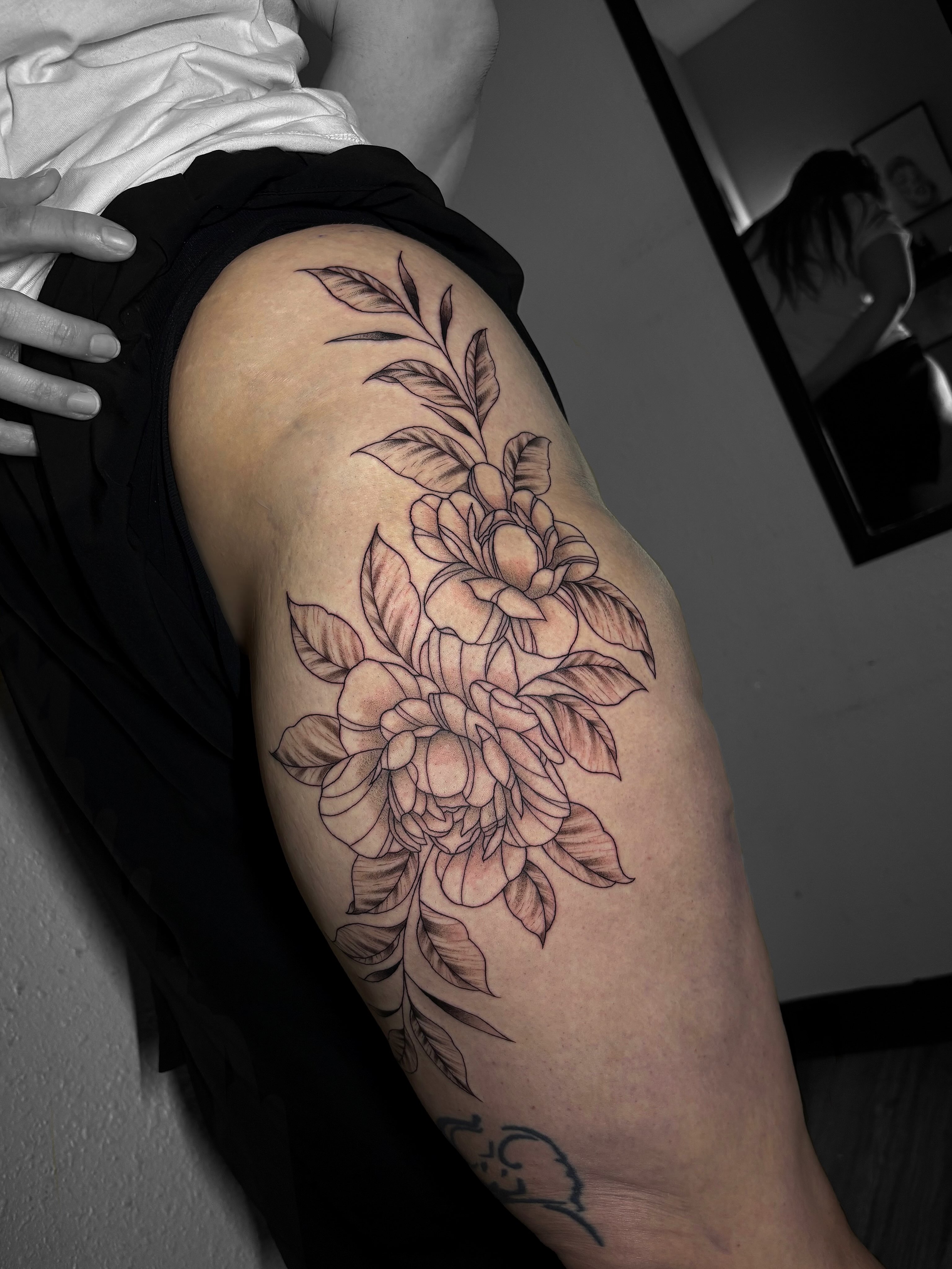 Floral bouquet black and grey tattoo on the thigh by Grace L