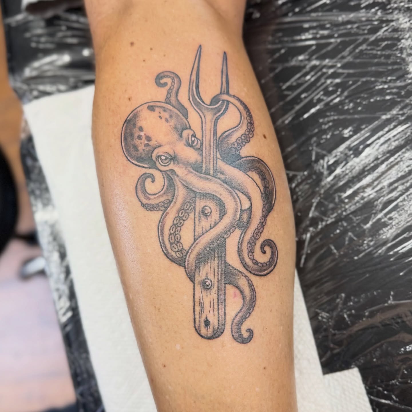 Octopus and trident black and grey tattoo on the forearm by Chuckthegirl