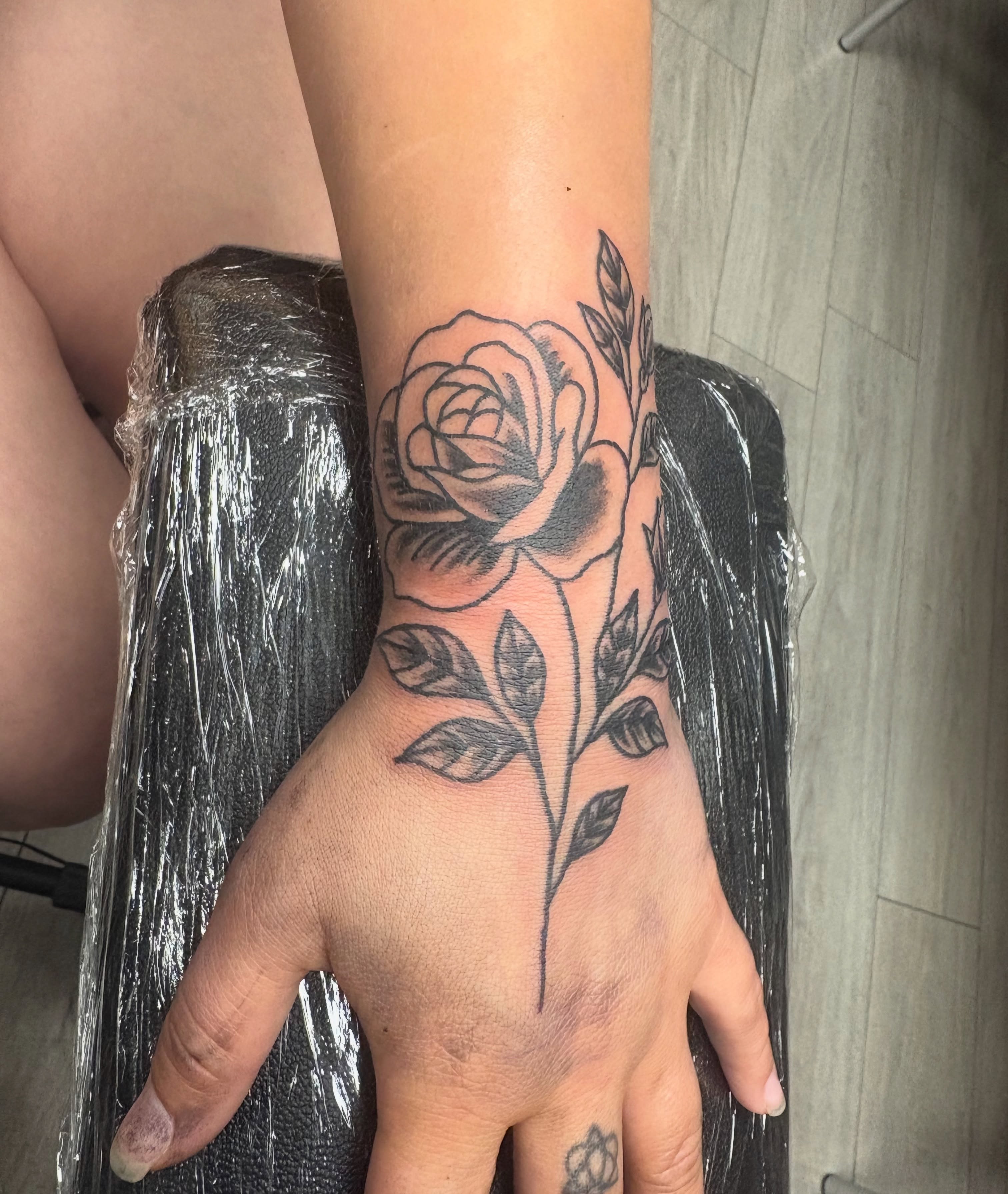 Rose black and grey tattoo on the hand by Landon Bagley