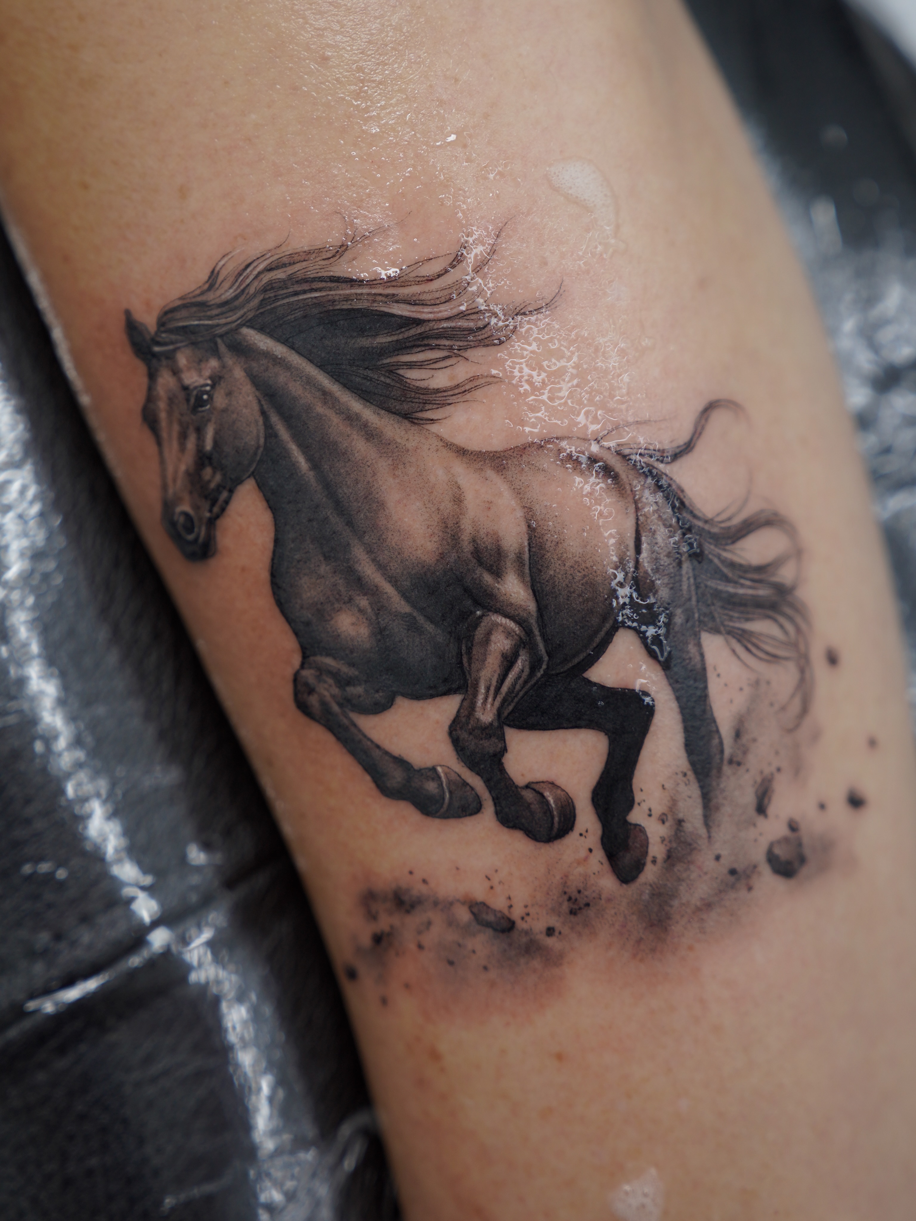 Galloping horse realism tattoo on the forearm by Tattoo Artist