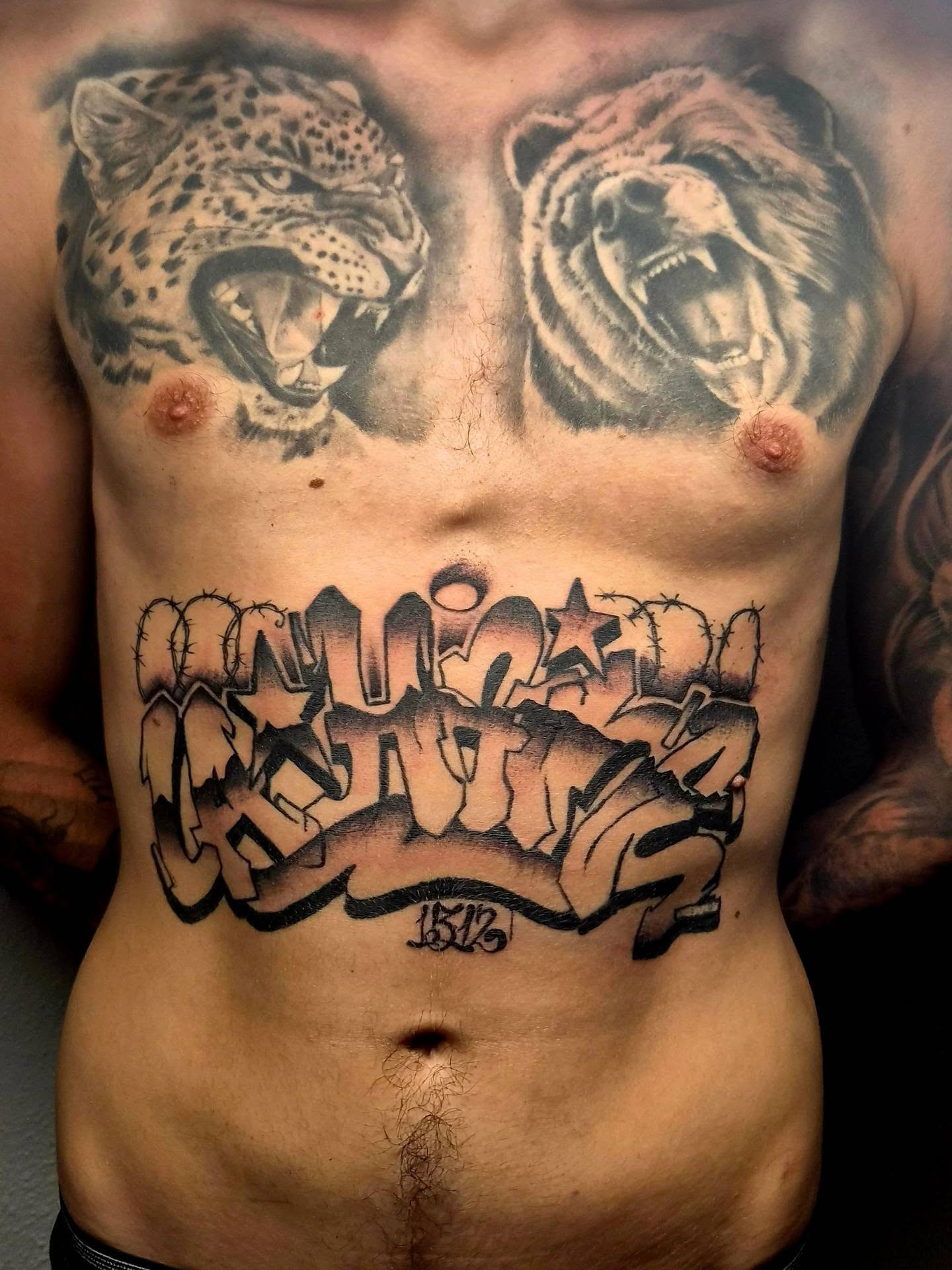 Graffiti-style text black and grey tattoo on the chest by Gonzalo Pantona
