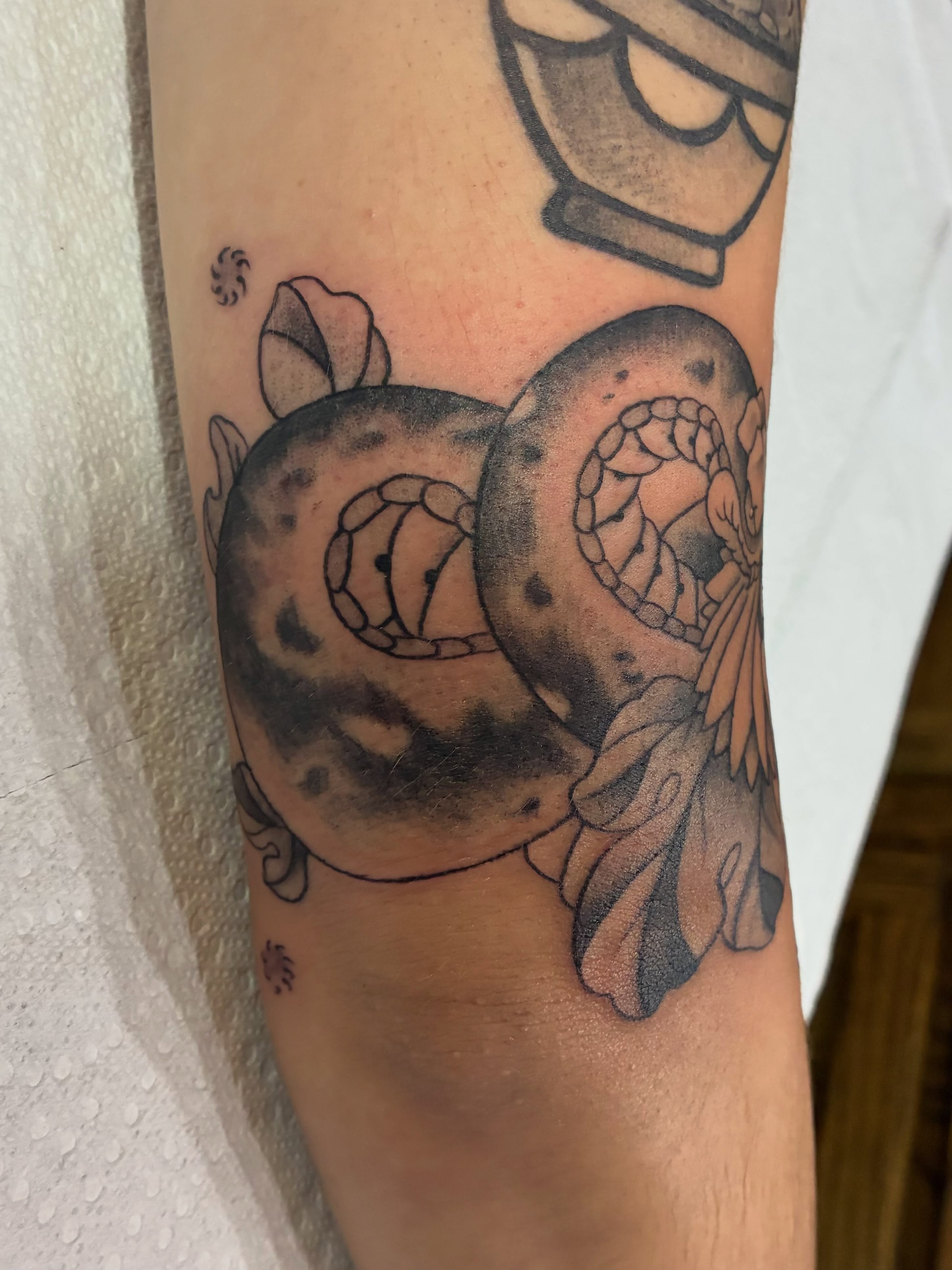 Octopus and flower black and grey tattoo on the forearm by Natalie Spuhler