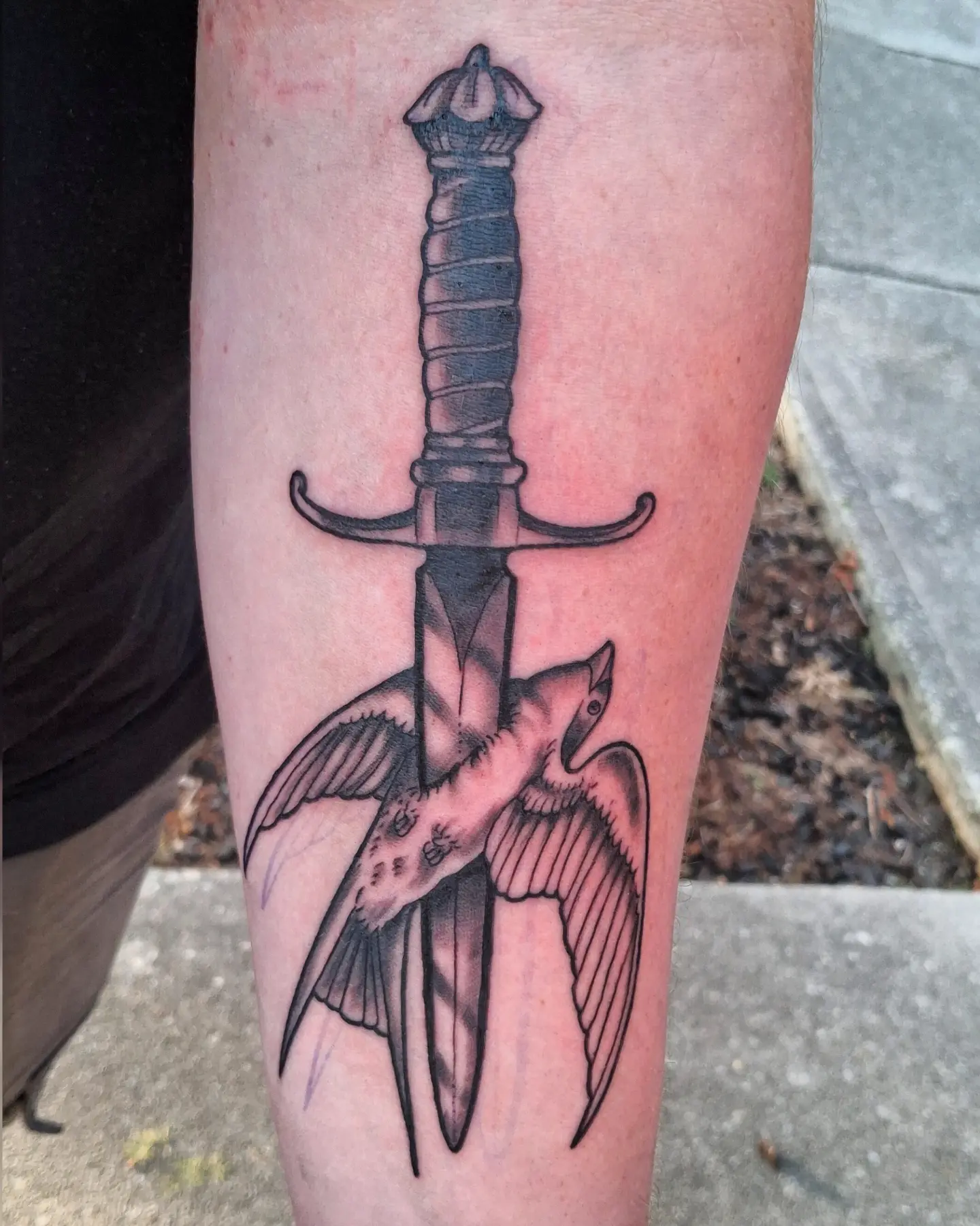 Sword and bird black and grey tattoo on the forearm by Jake Mincey