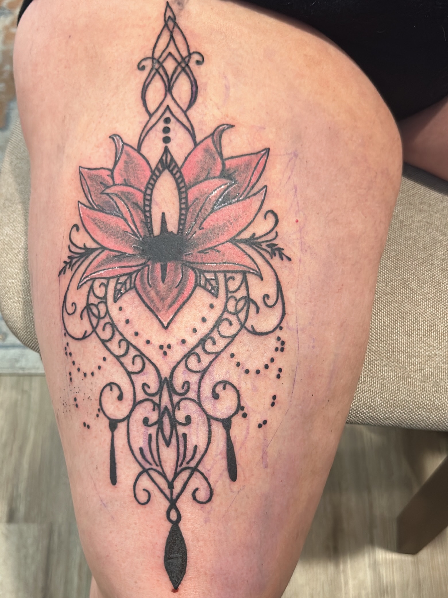 Lotus flower dotwork tattoo on the thigh by @tatzbythadon