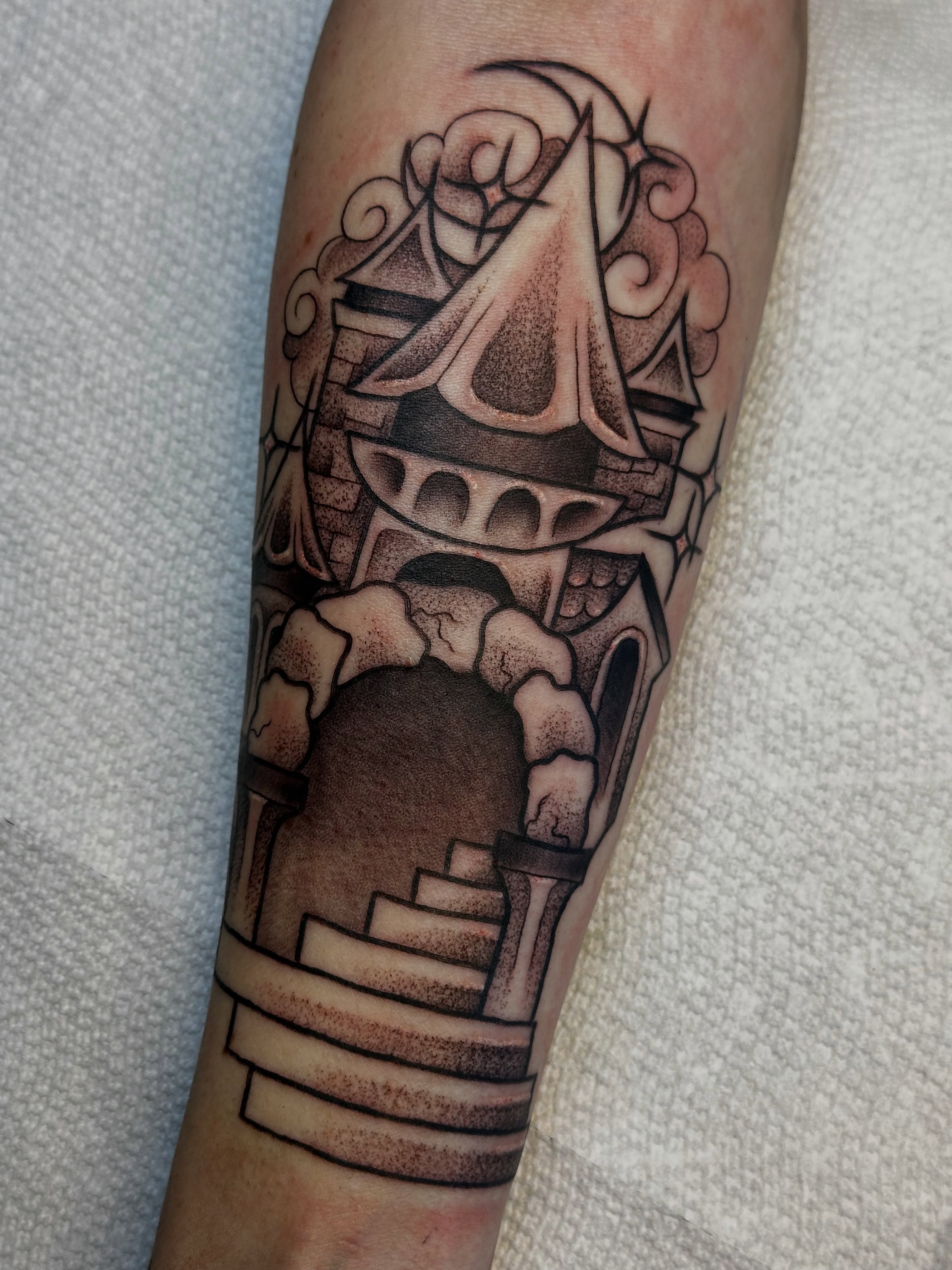 Castle black and grey tattoo on the forearm by Elisha B🦷