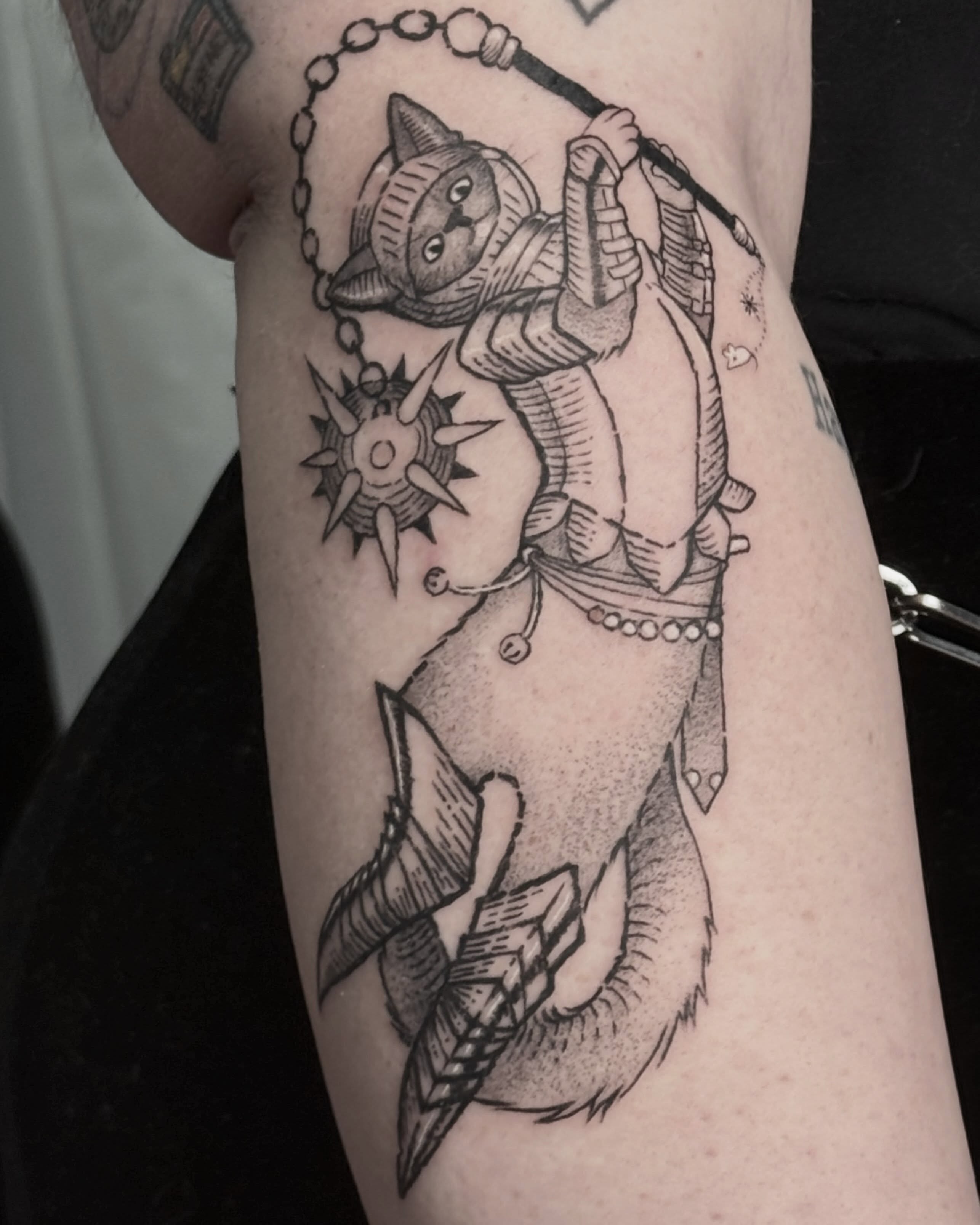 Cat riding shark black and grey tattoo on the forearm by Christian