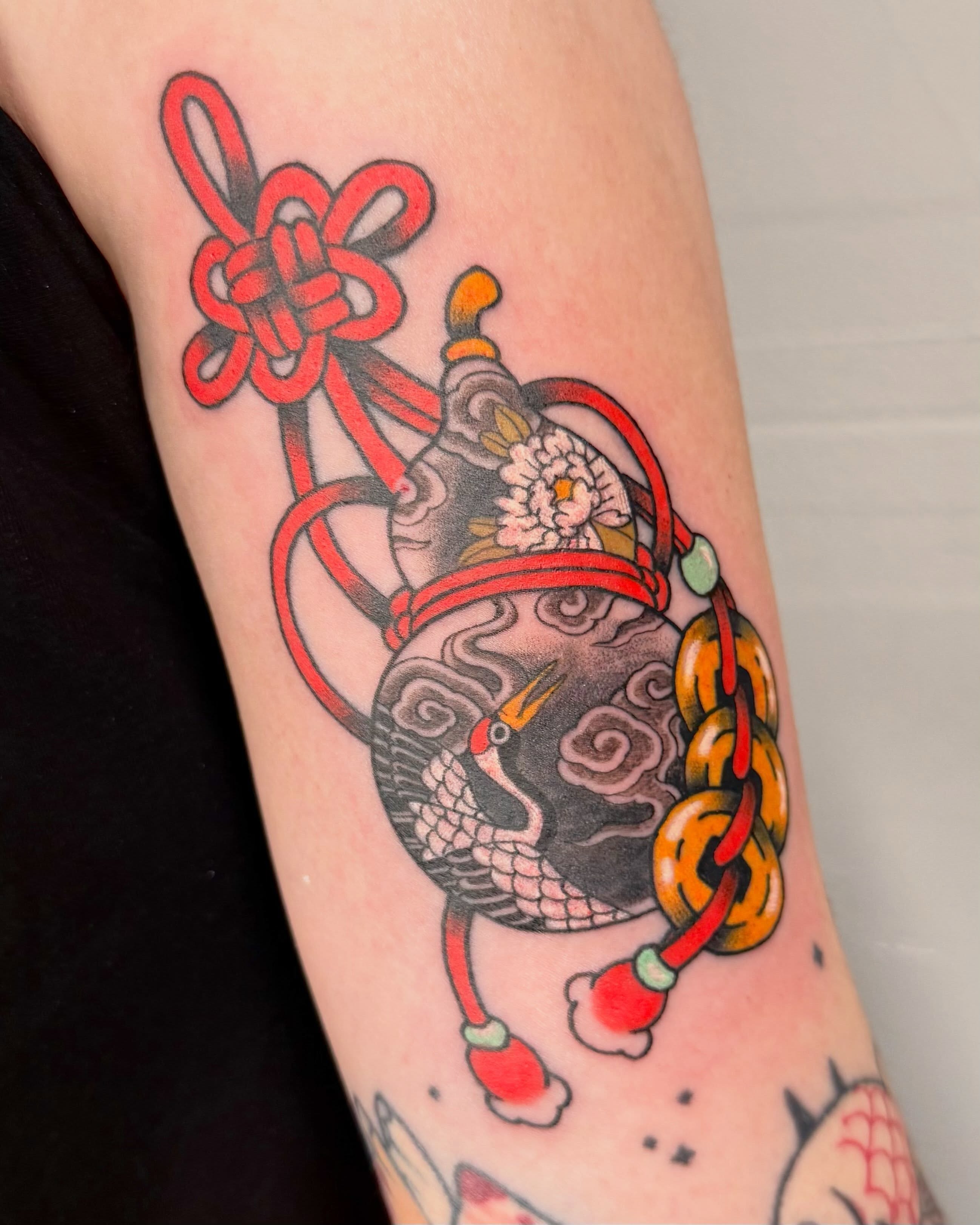 Crane and knot American traditional tattoo on the forearm by binh