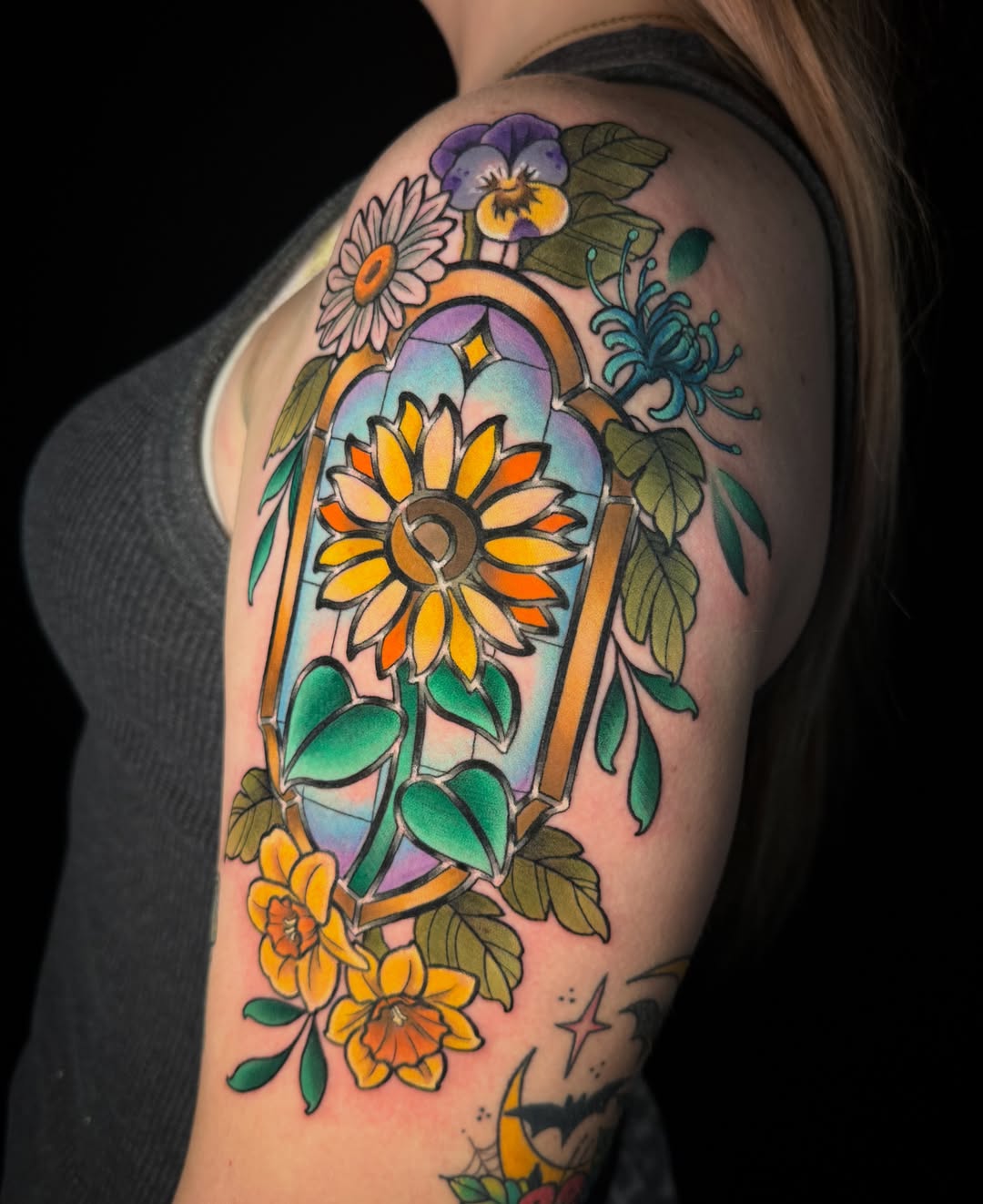Sunflower and floral arrangement American traditional tattoo on the shoulder by Dee Florian