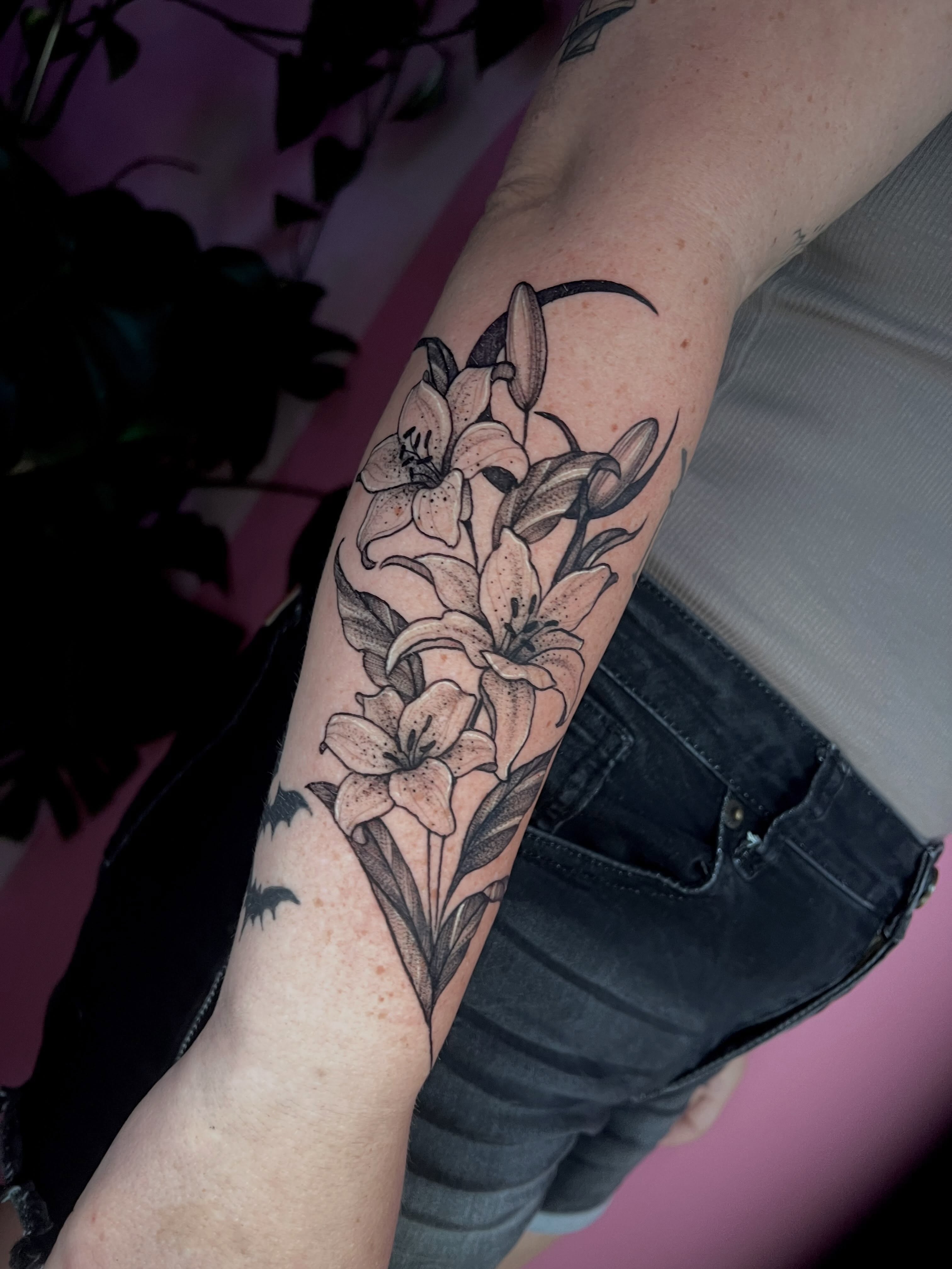 Lilies black and grey tattoo on the forearm by jessica valentine
