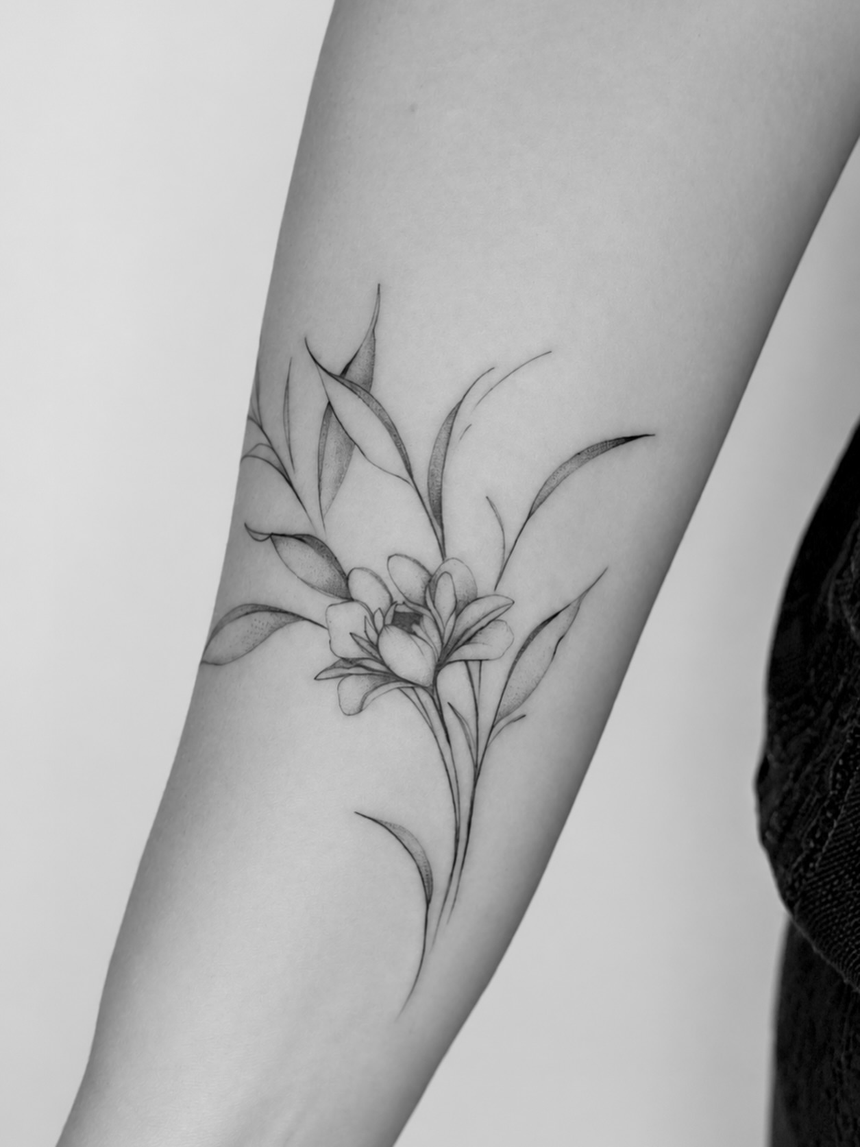 Lily black and grey tattoo on the forearm by Tattoo Artist & Piercer ▪️alona Zamsh