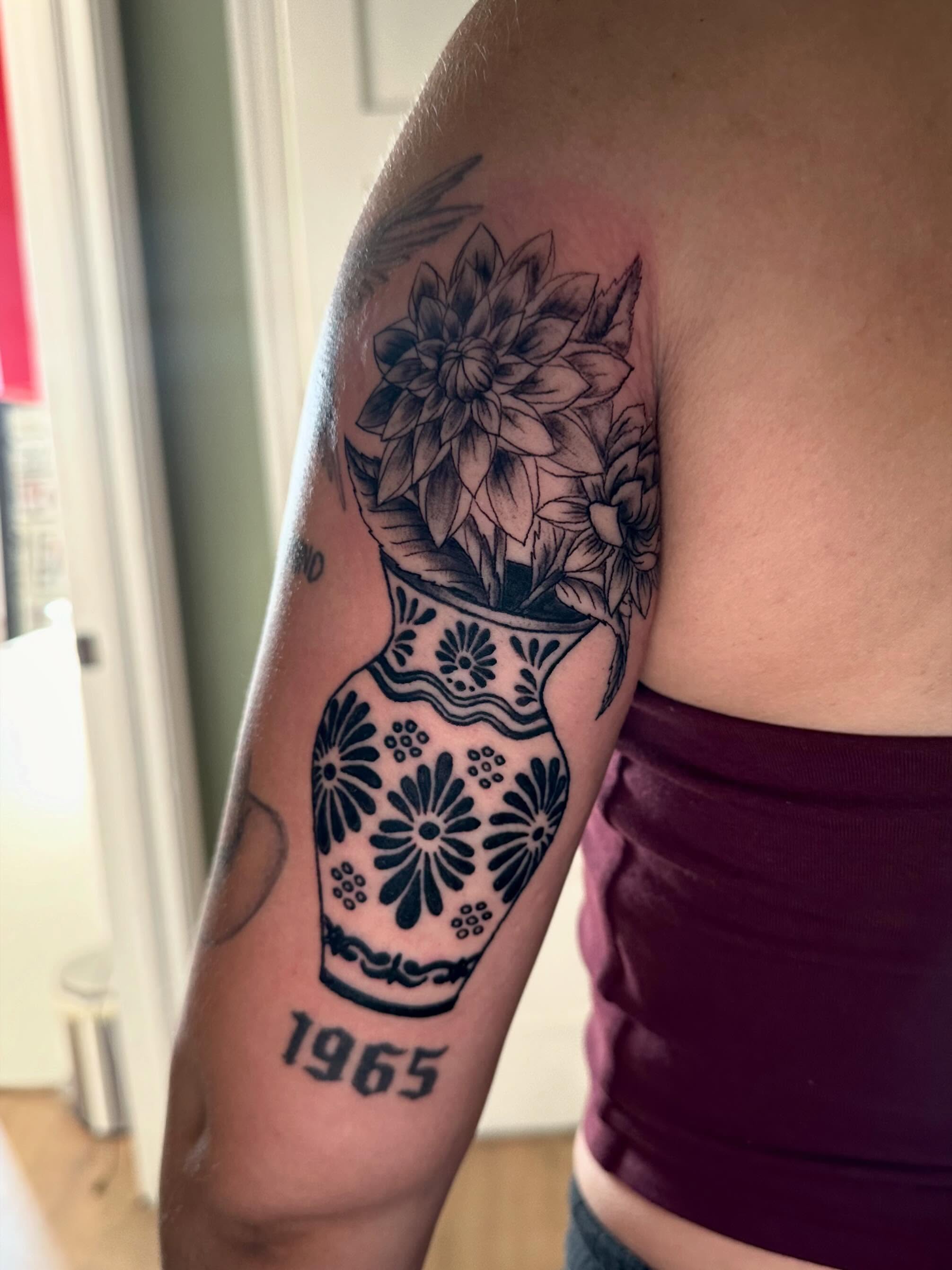 Sugar skull with flowers black and grey tattoo on the forearm by Kaylee Woods