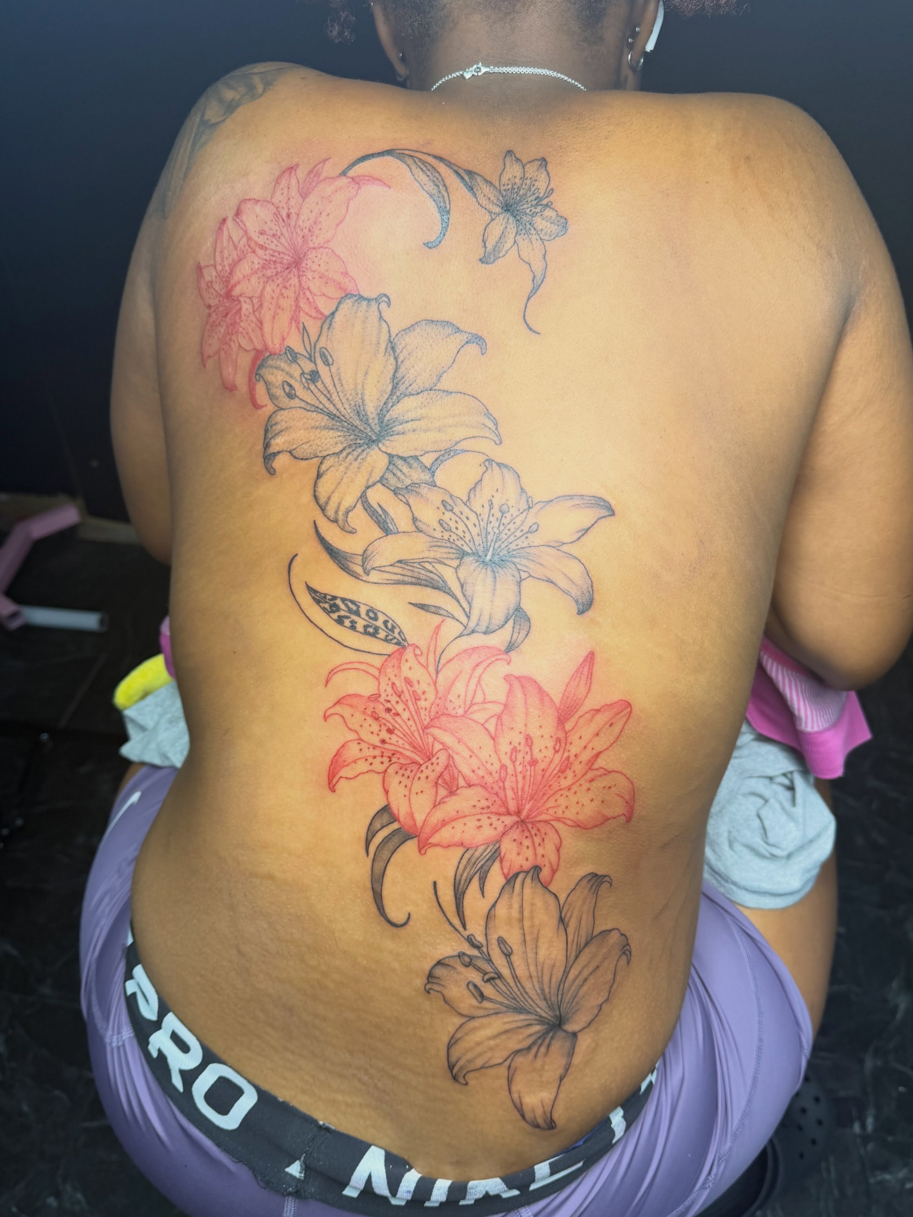 Lilies black and grey tattoo on the back by addicted222inkk🎨