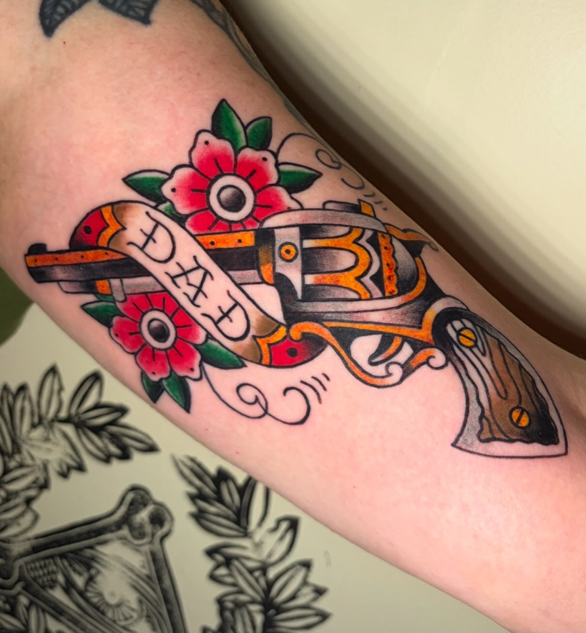 Gun and flowers American traditional tattoo on the forearm by Las Vegas Tattoo Artist, Las Vegas, Nevada