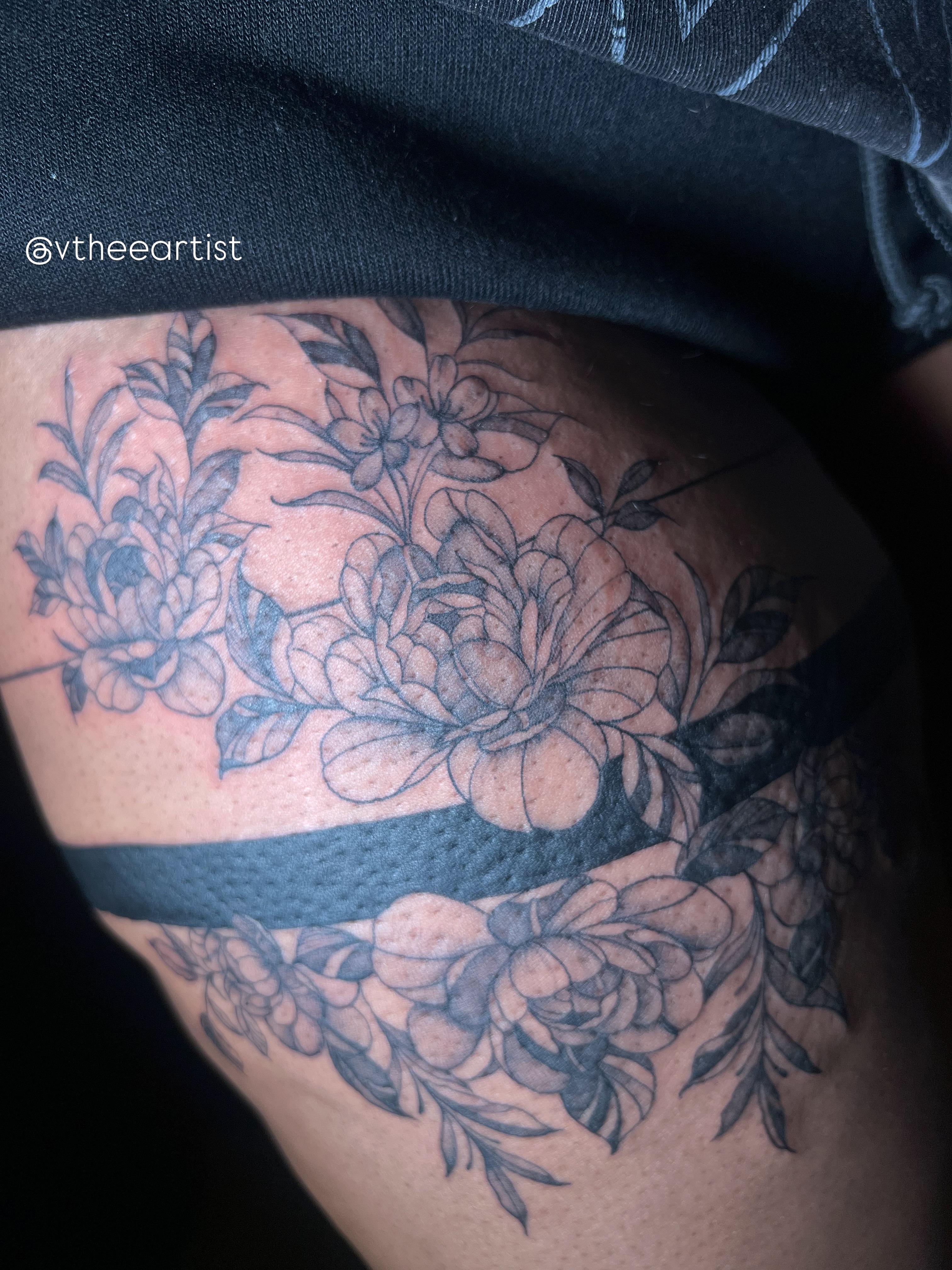Floral arrangement black and grey tattoo on the thigh by V