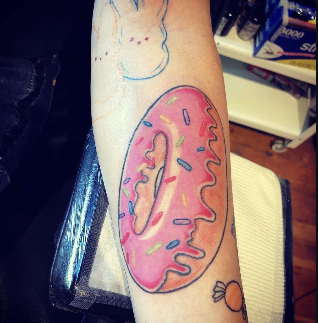 Donut new school tattoo on the forearm by Josh O’ + Bird ☘️ 🪶
