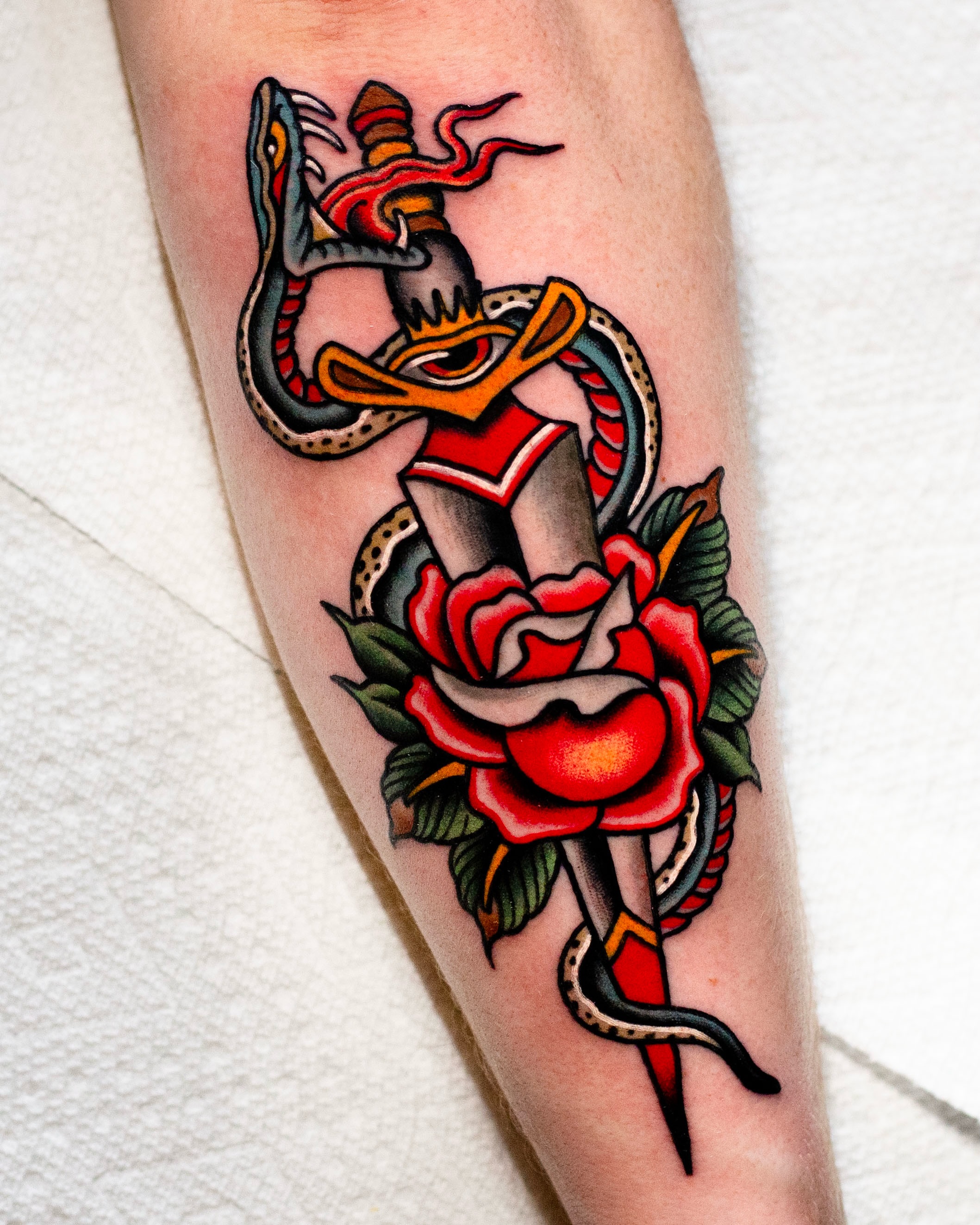 Snake and dagger American traditional tattoo on the forearm by Miguel Comin