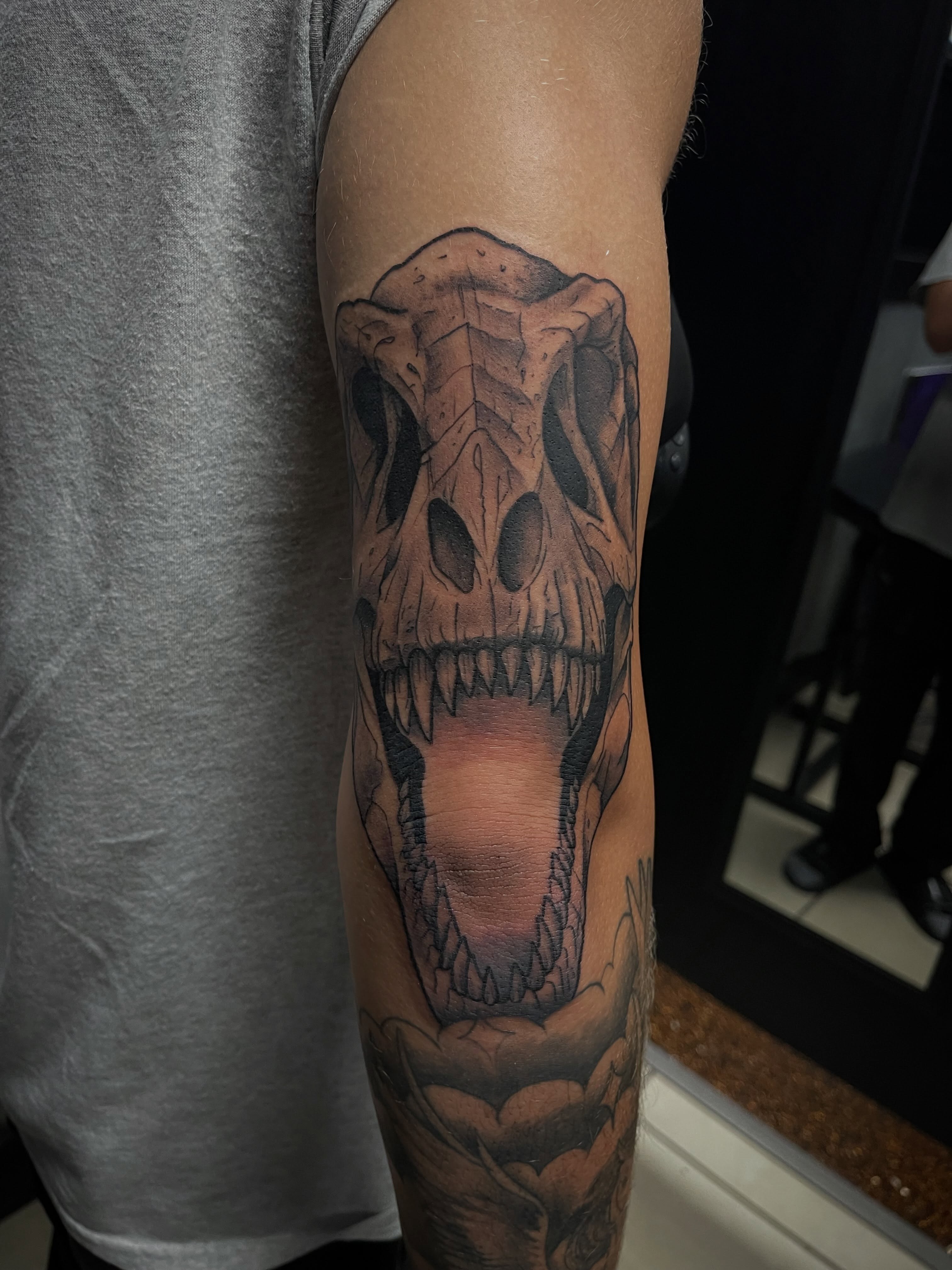 Dinosaur skull realism tattoo on the forearm by Chris Torres