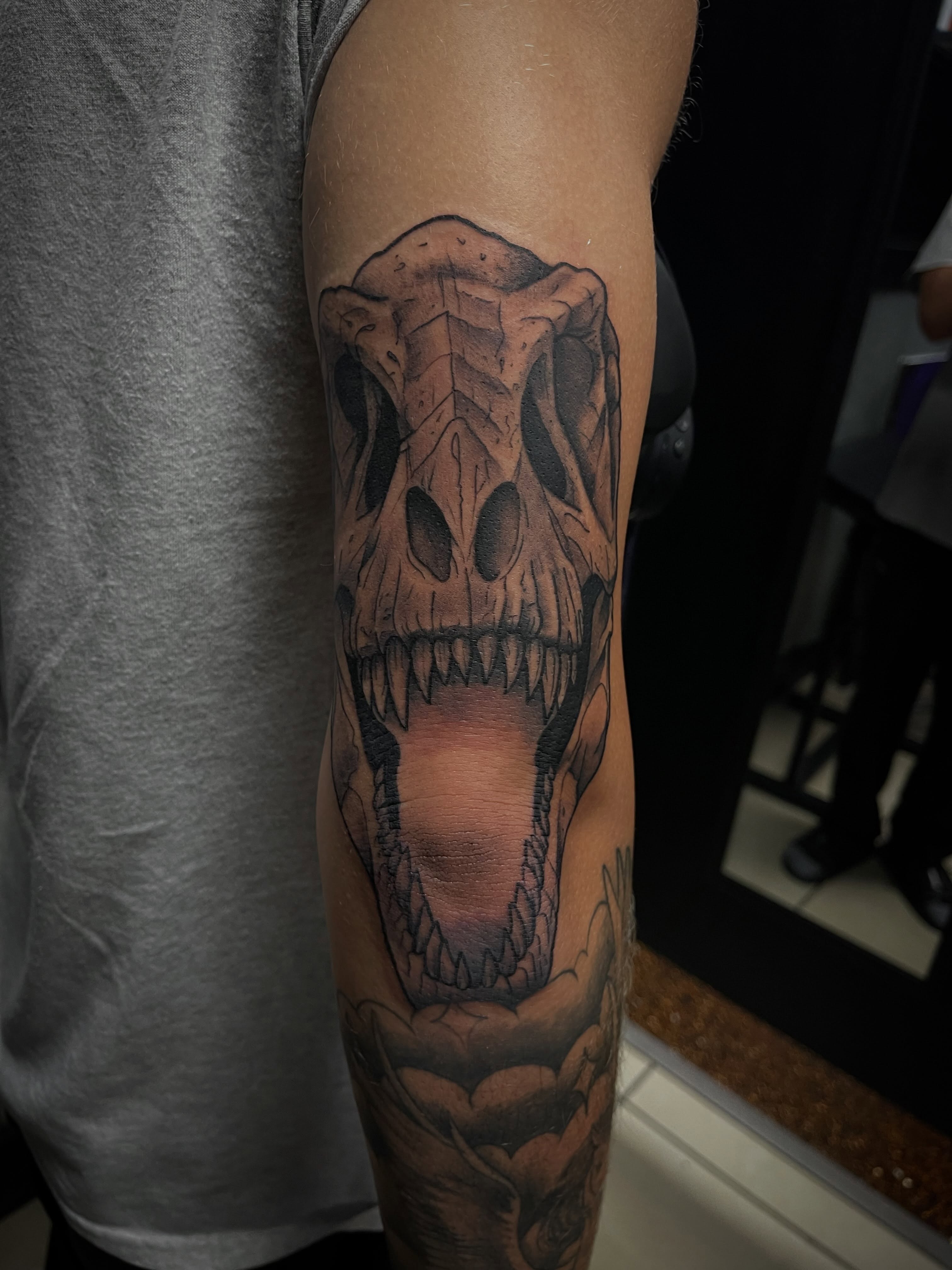 Skull realism tattoo on the forearm by Chris Torres