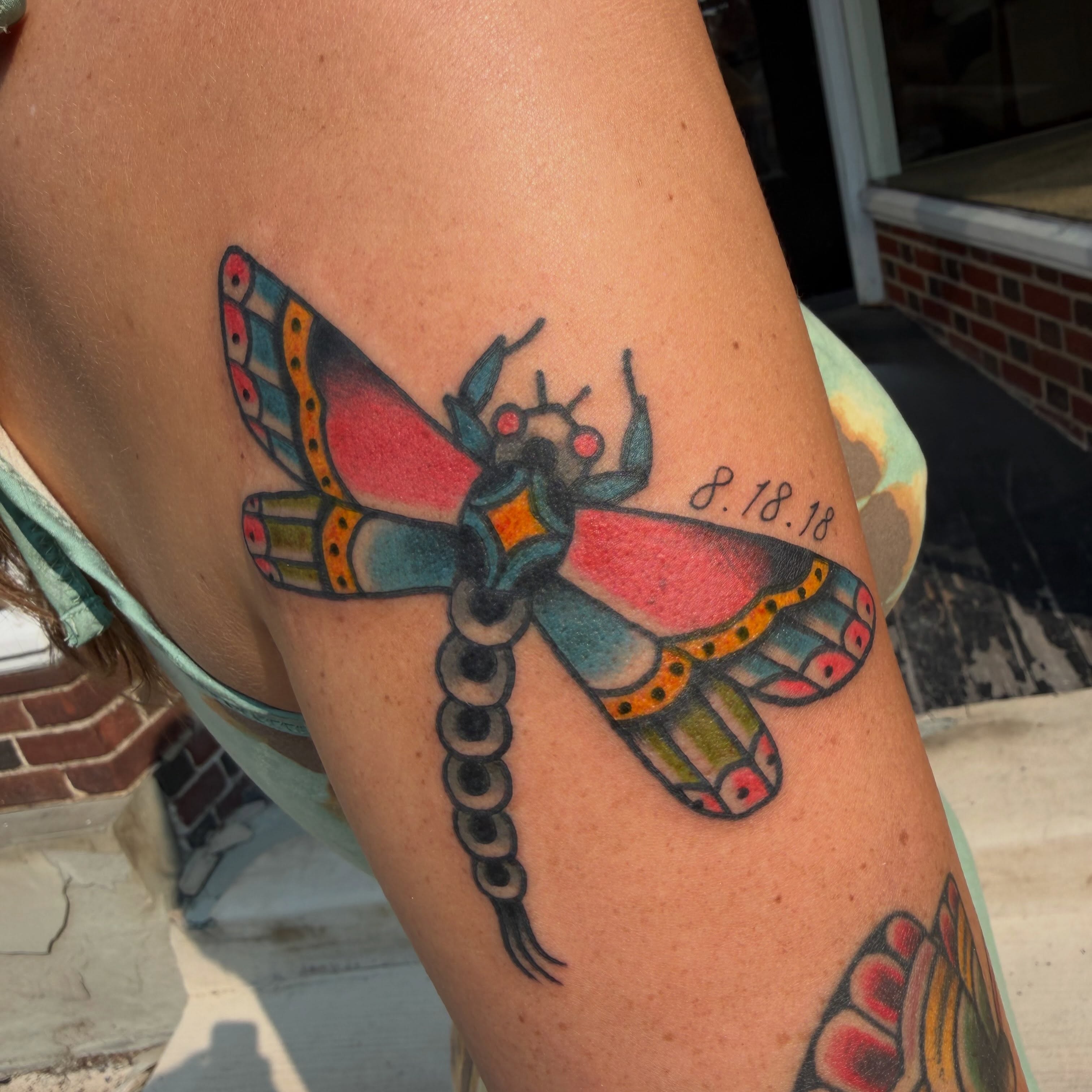 Dragonfly American traditional tattoo on the thigh by Hannah Jean