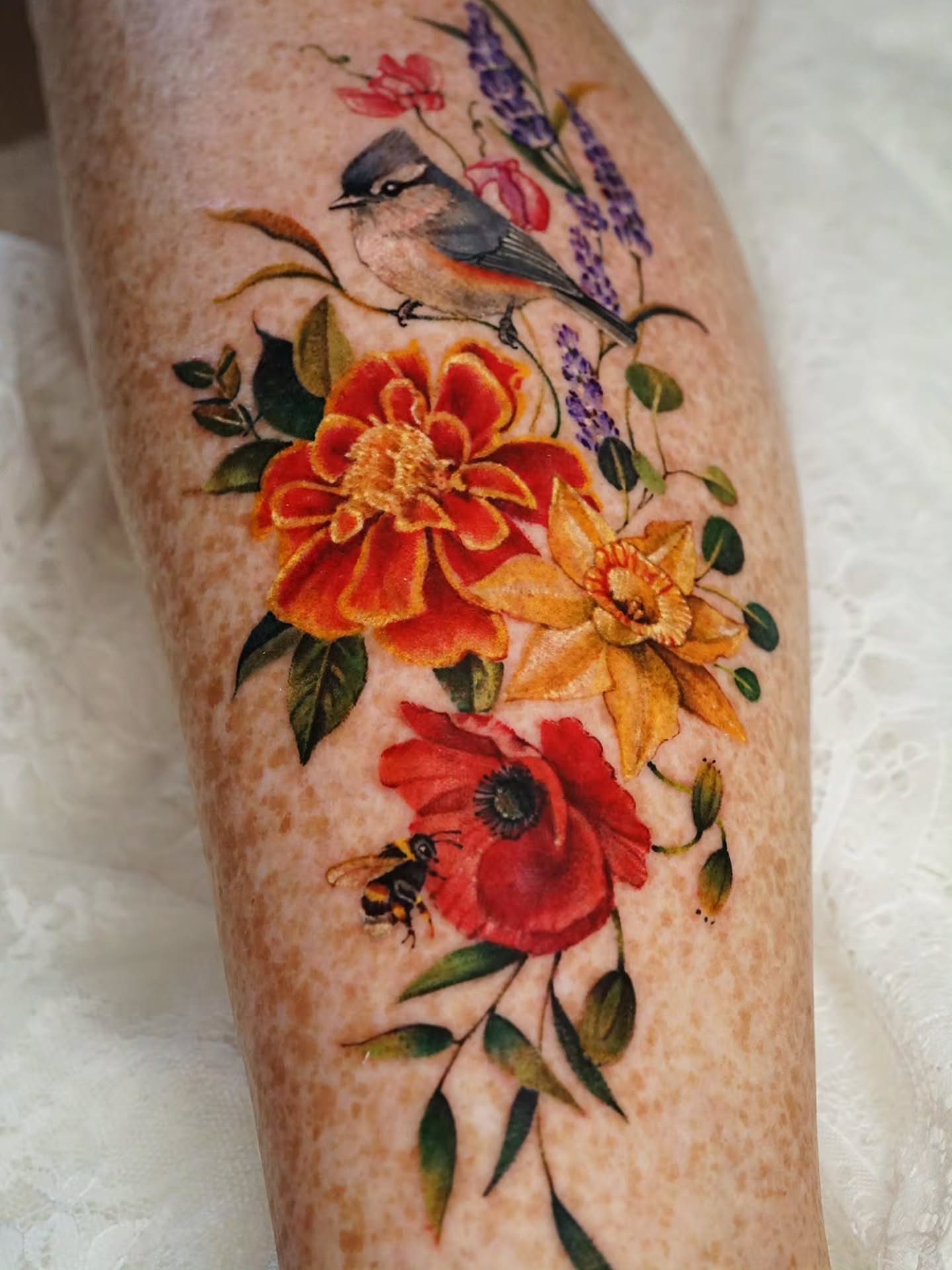 Bird and flowers realism tattoo on the leg by Vii