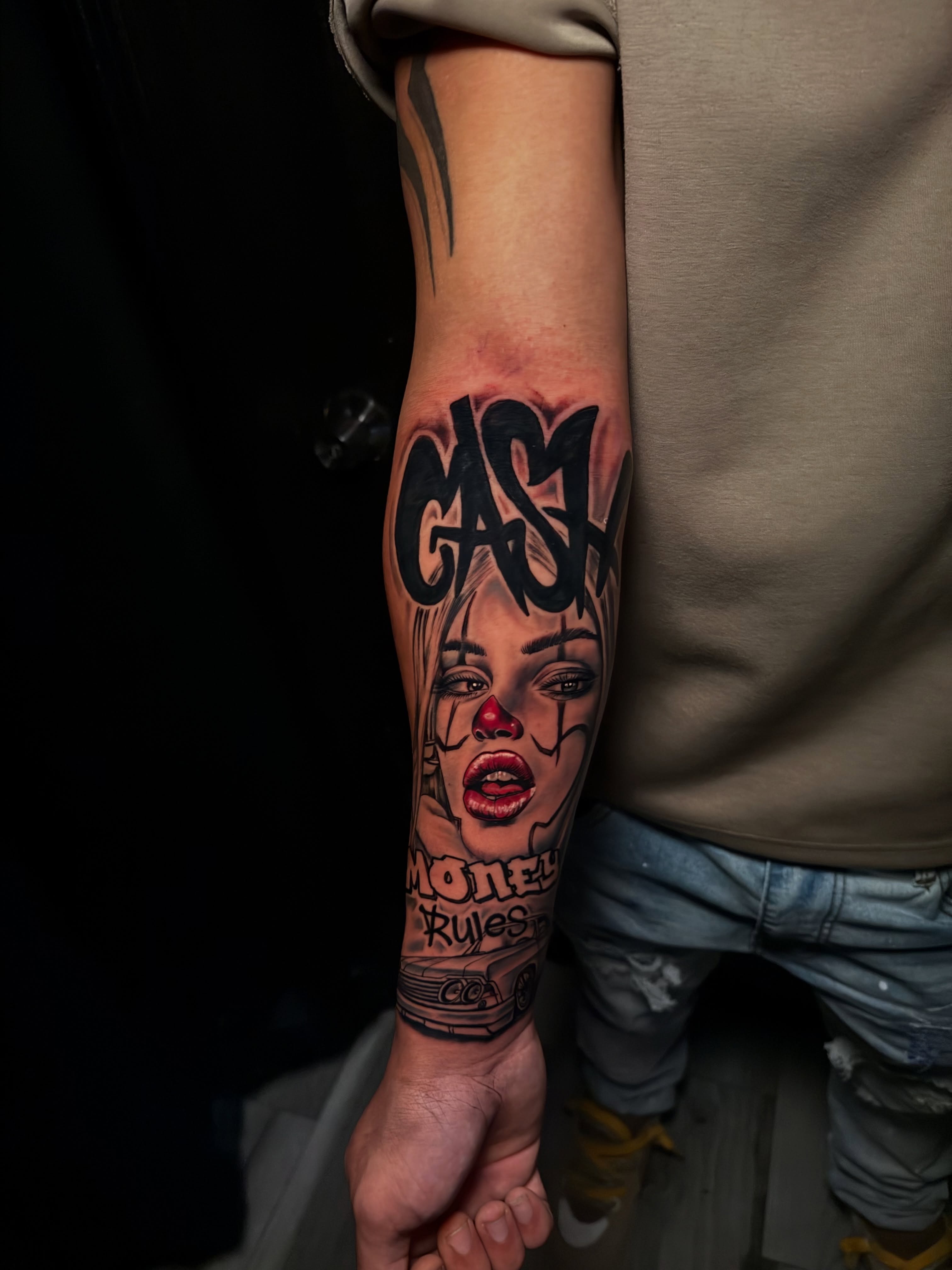 Clown face realism tattoo on the forearm by Alex