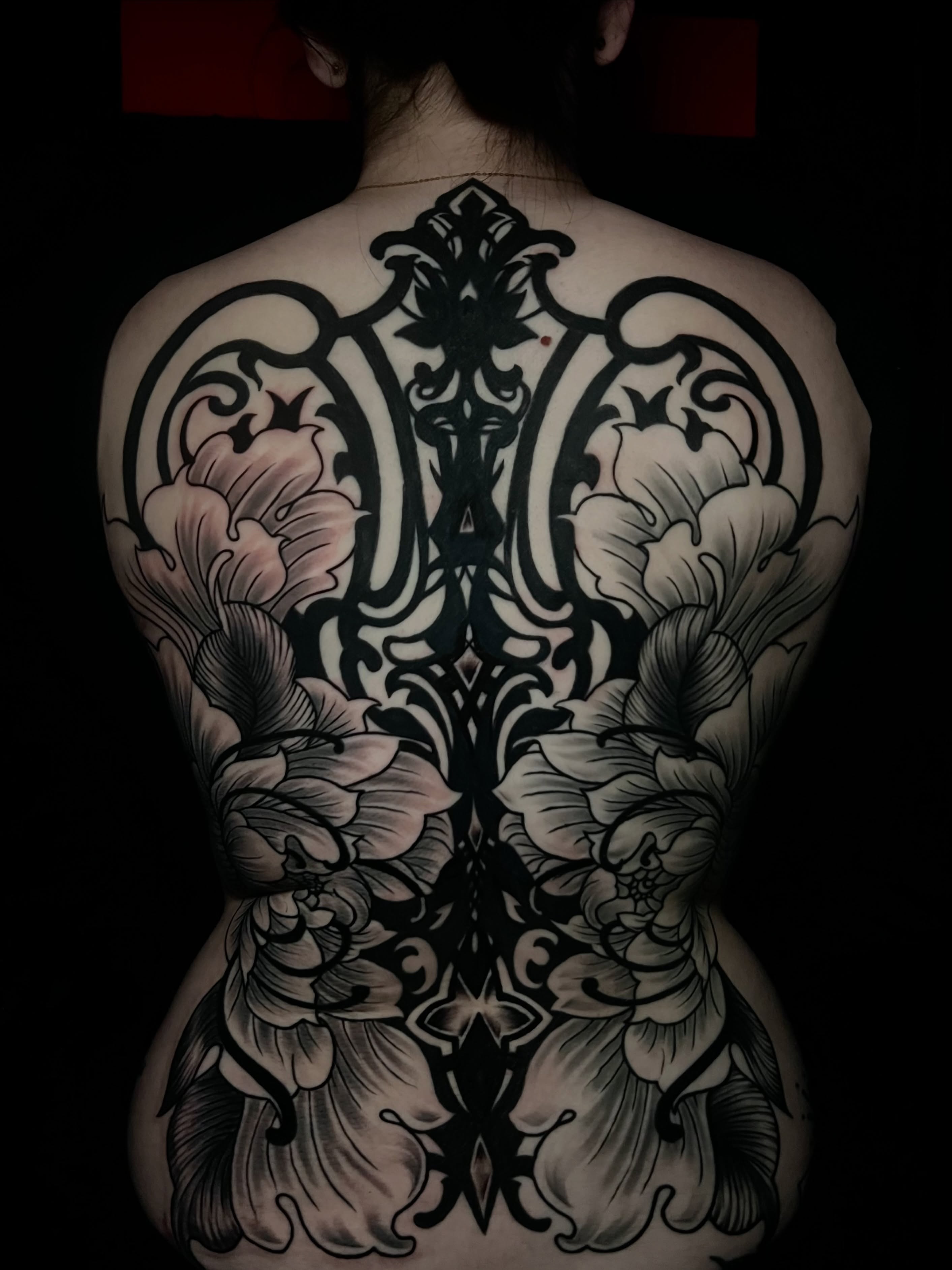 Floral design black and grey tattoo on the back by Alex