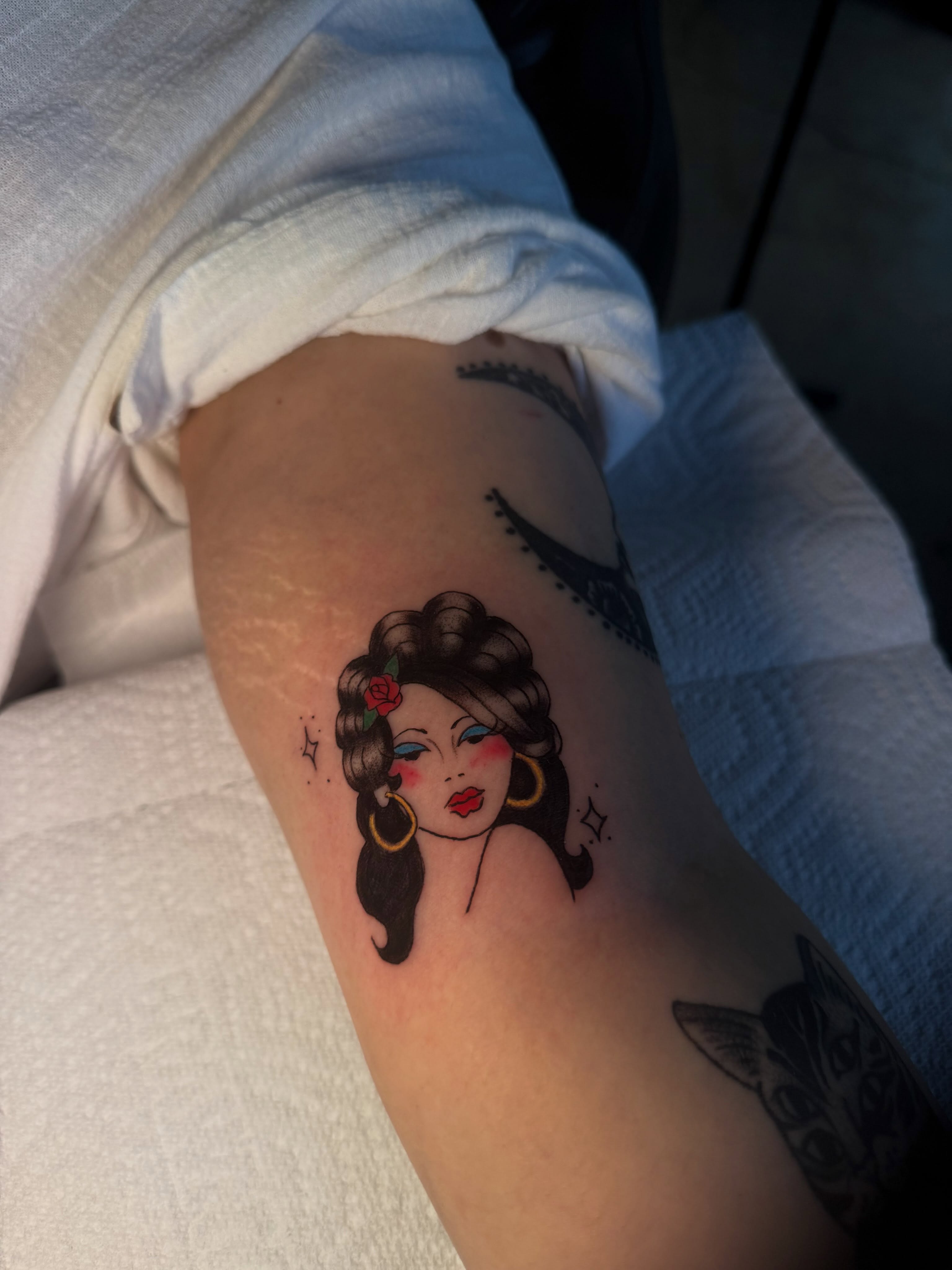 Woman with flower American traditional tattoo on the forearm by Giana Martinez, Wichita, Kansas