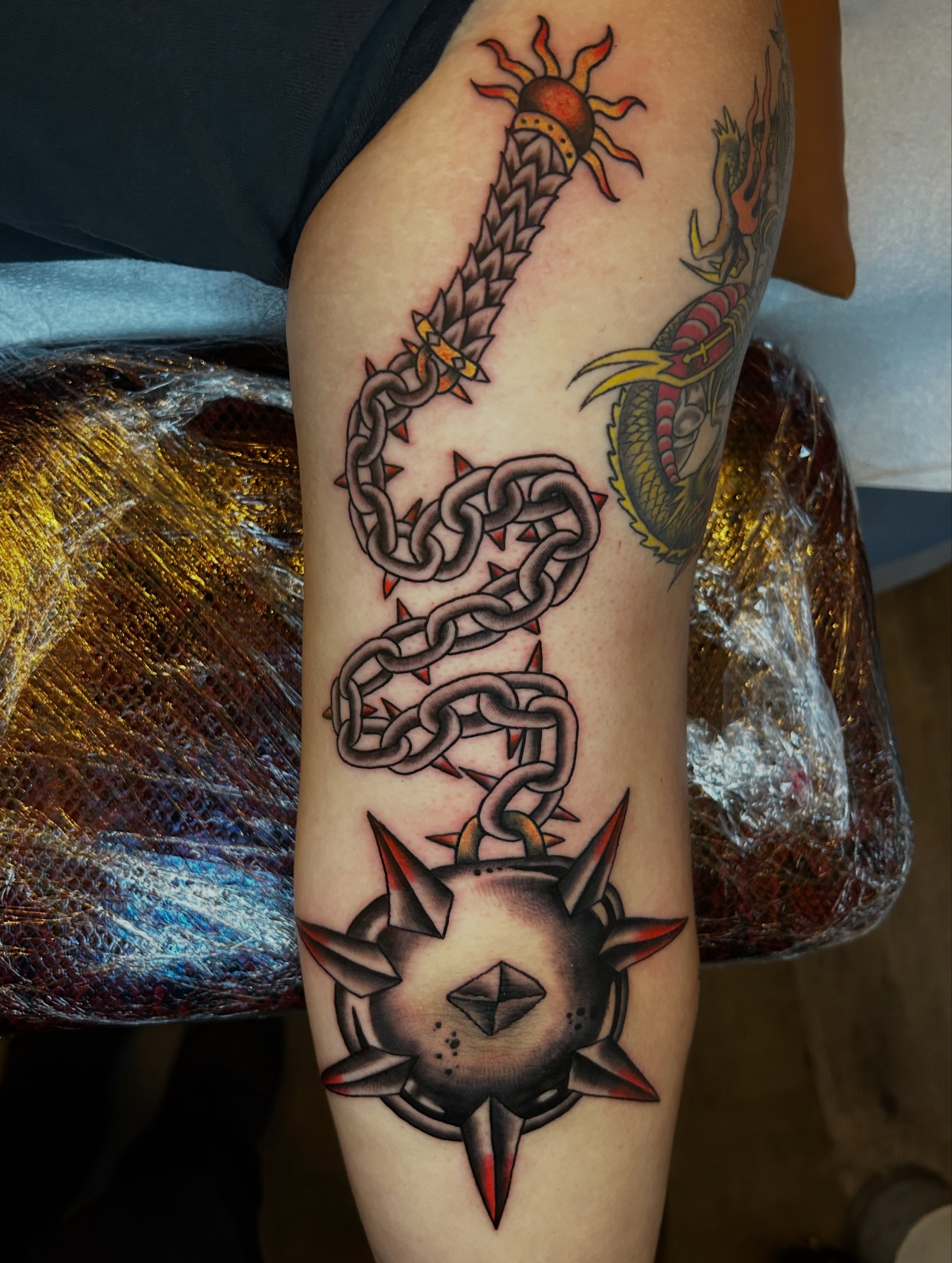 Chain and spiked ball American traditional tattoo on the forearm by Kurt, Somerville, Massachusetts
