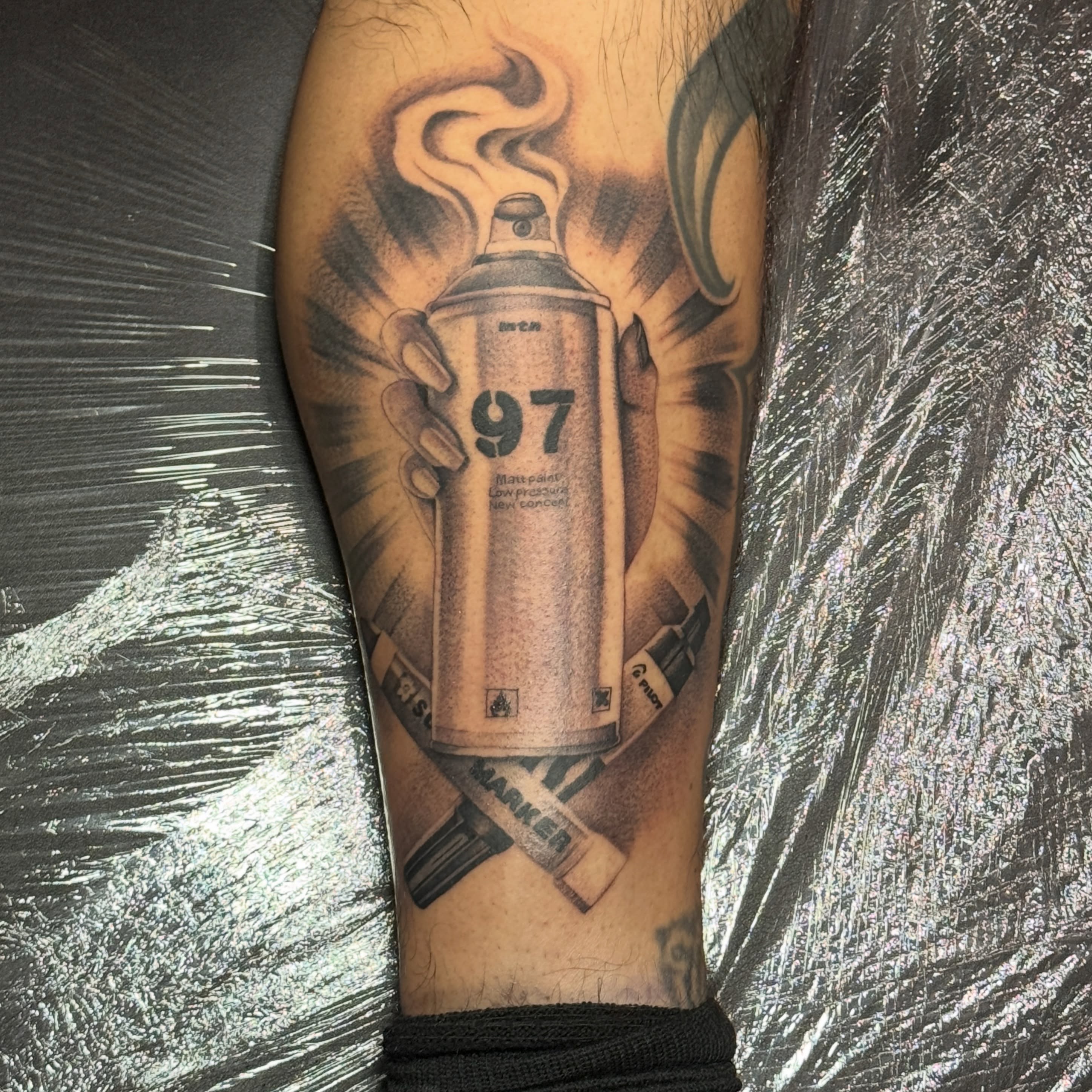 Spray paint can realism tattoo on the forearm by tombstone