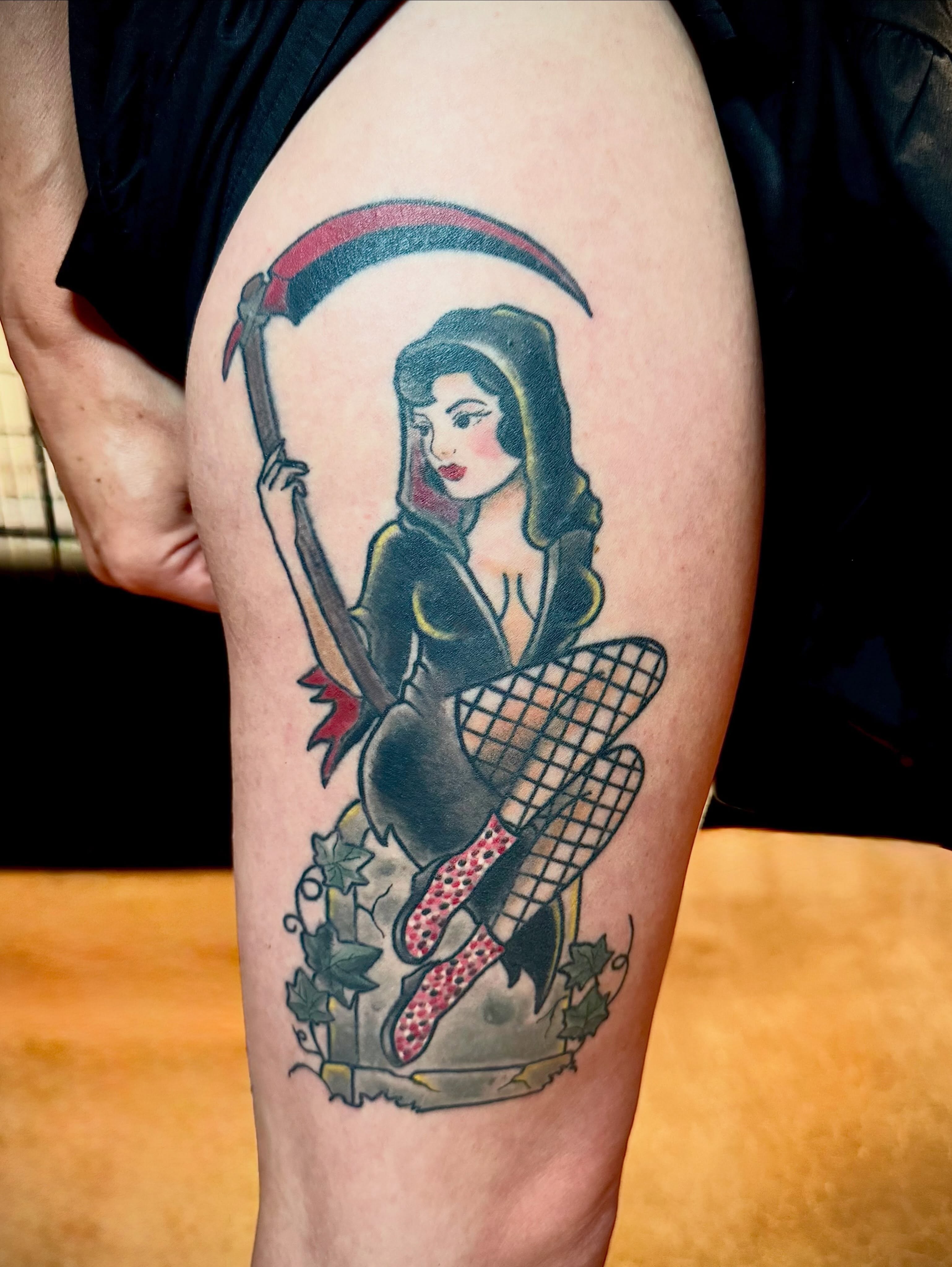 Grim reaper pin-up American traditional tattoo on the thigh by San Diego Tattoo Artist