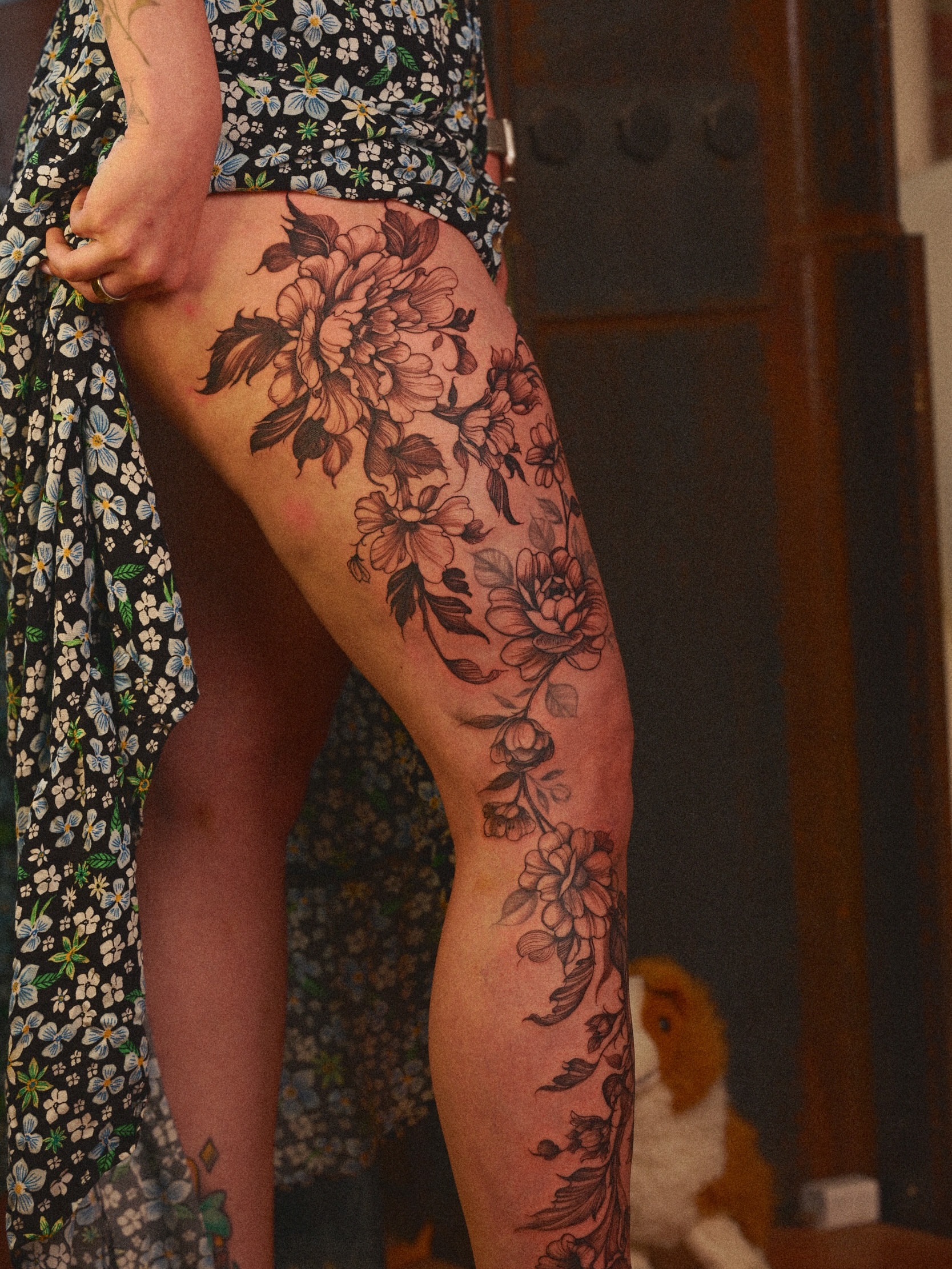 Floral bouquet black and grey tattoo on the thigh by Brad Simmons