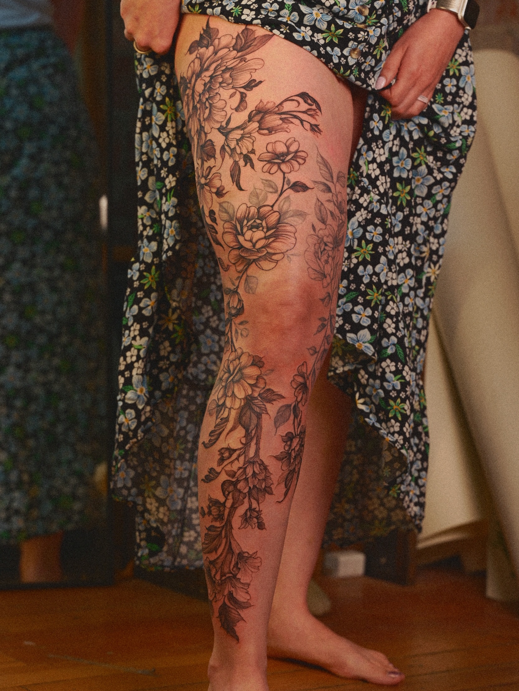 Floral bouquet black and grey tattoo on the thigh by Brad Simmons