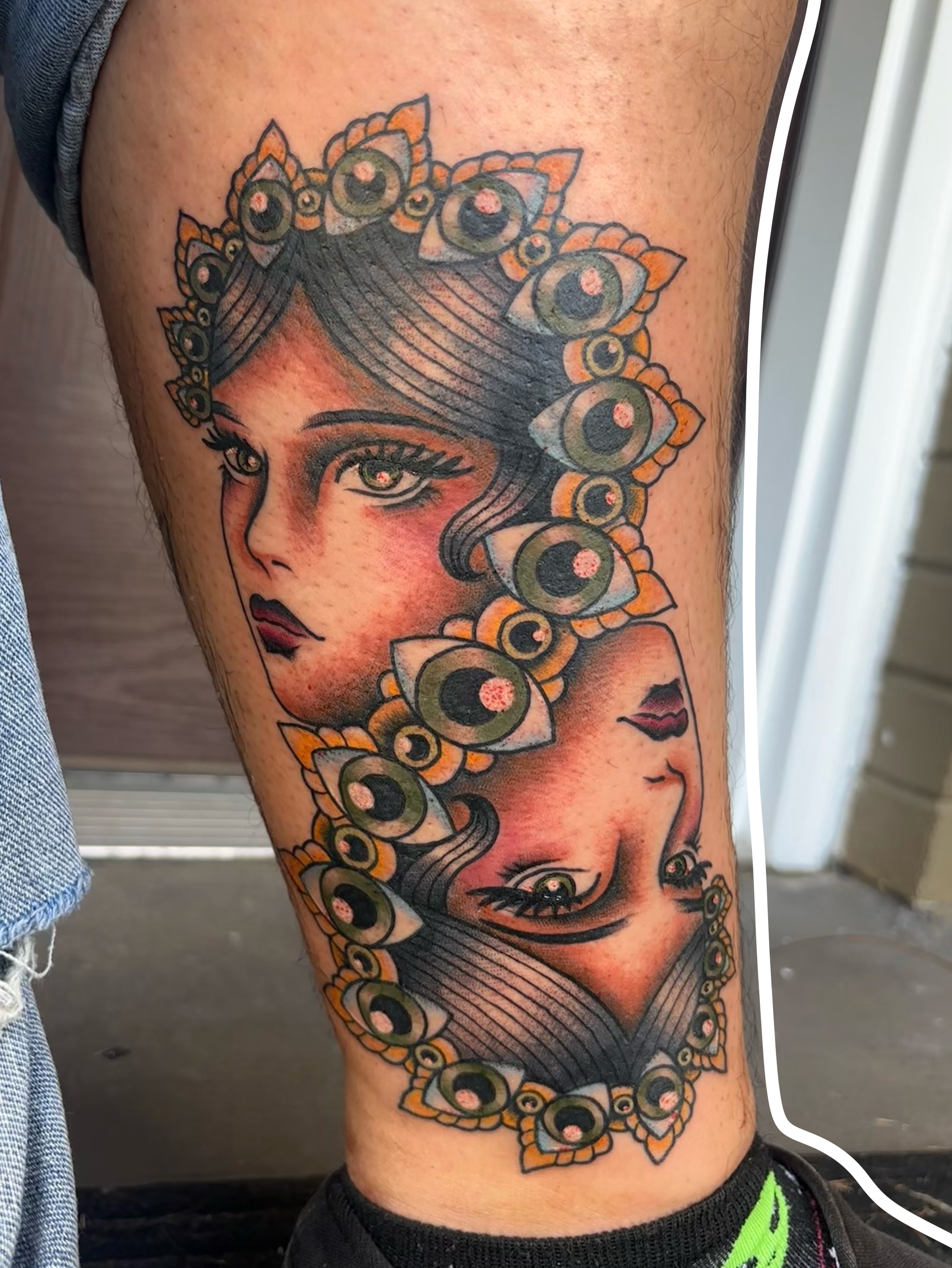 Woman with eyes illustrative tattoo on the thigh by Emmy Stepien