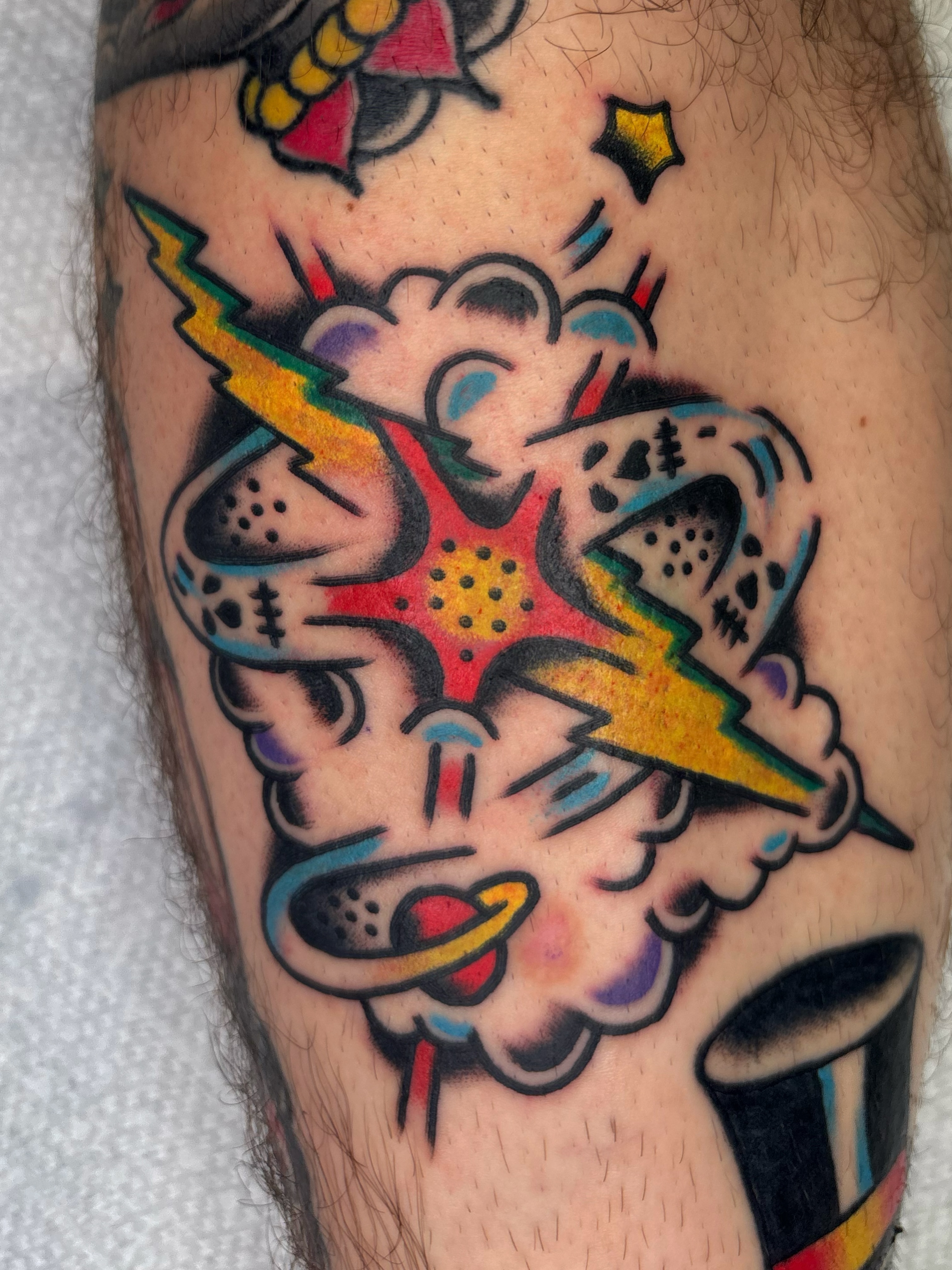 Comic-style explosion American traditional tattoo on the forearm by Cooper Reichwein