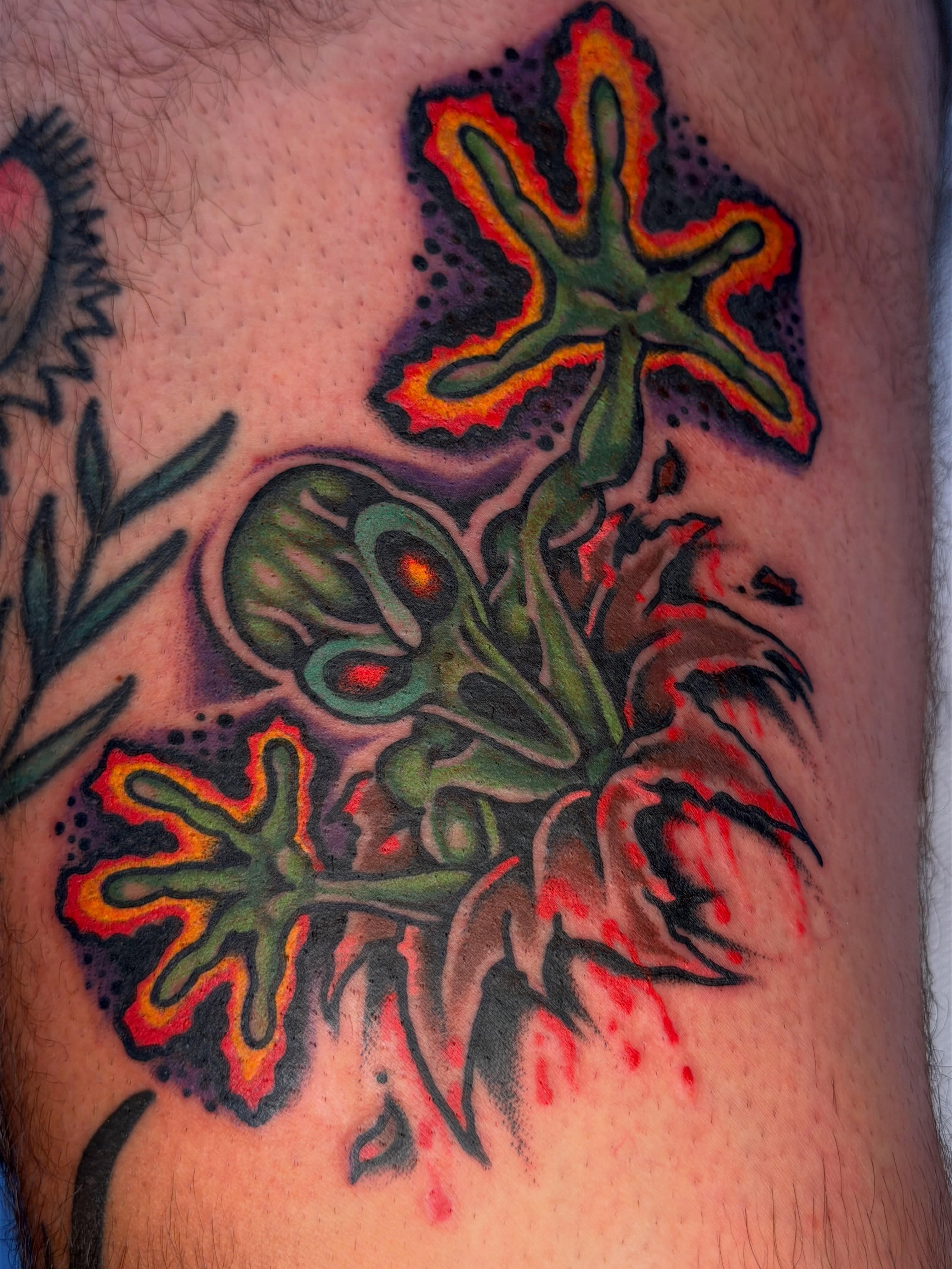 Alien flower American traditional tattoo on the thigh by Joshua Speight