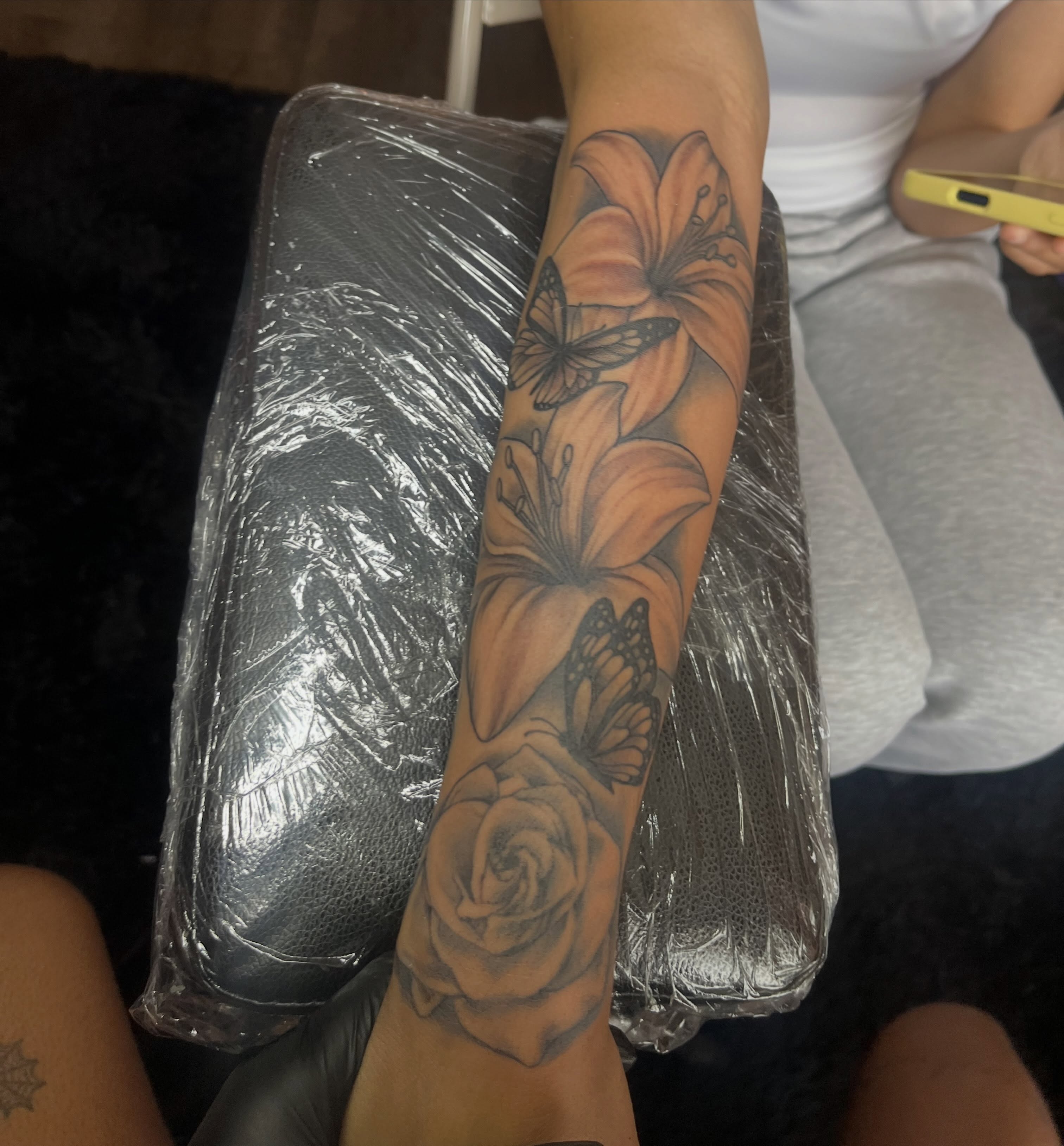 Flowers and butterflies realism tattoo on the forearm by Tam💟👩🏽‍🎨