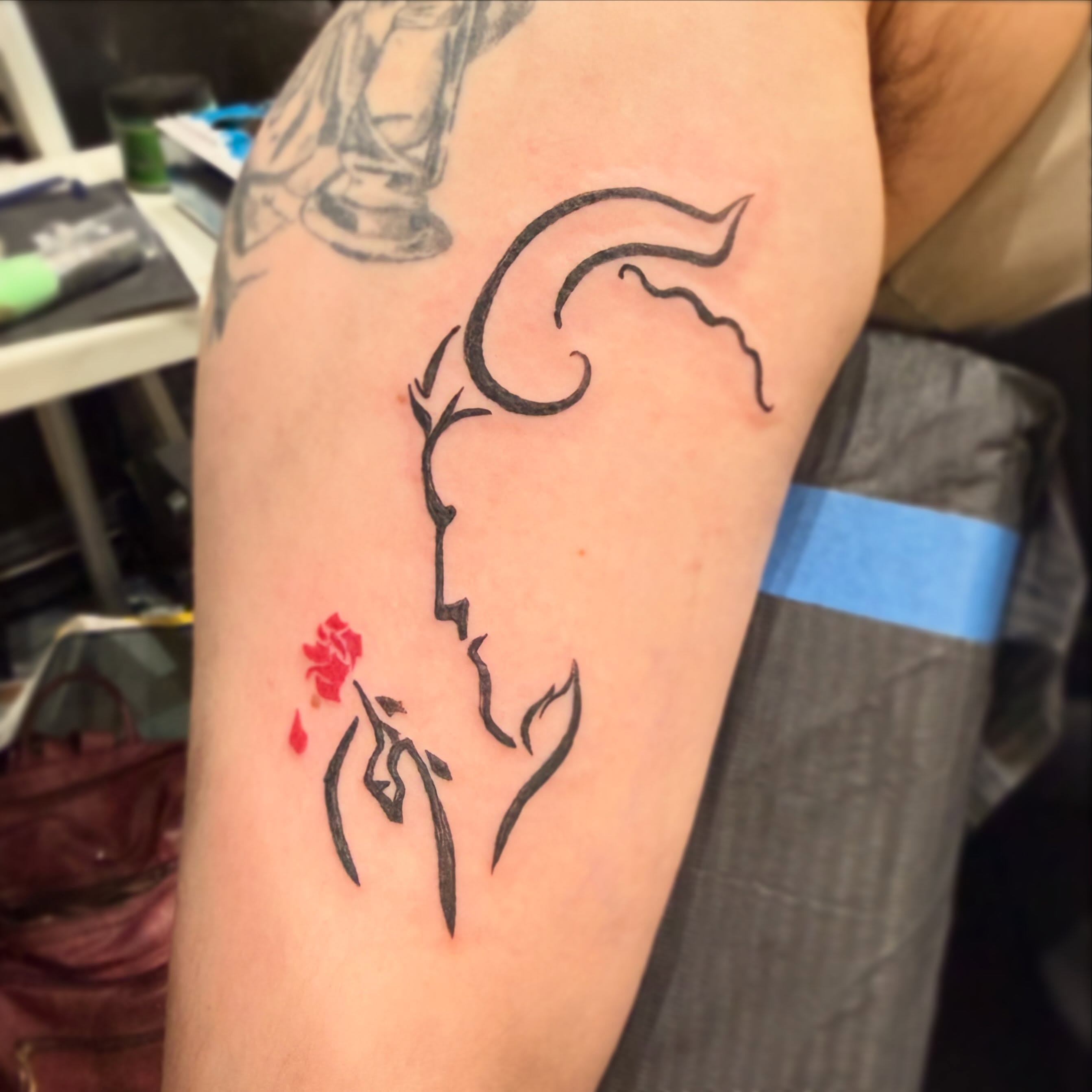 Rose and silhouette fine line tattoo on the forearm by Darby Antonucci