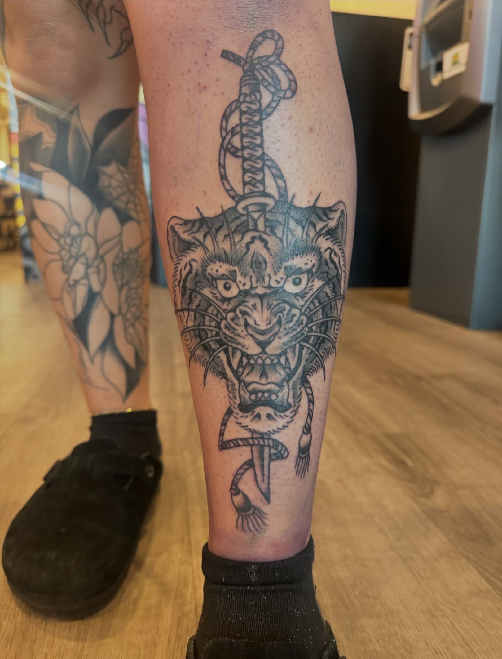 Roaring tiger black and grey tattoo on the calf by Minneapolis
