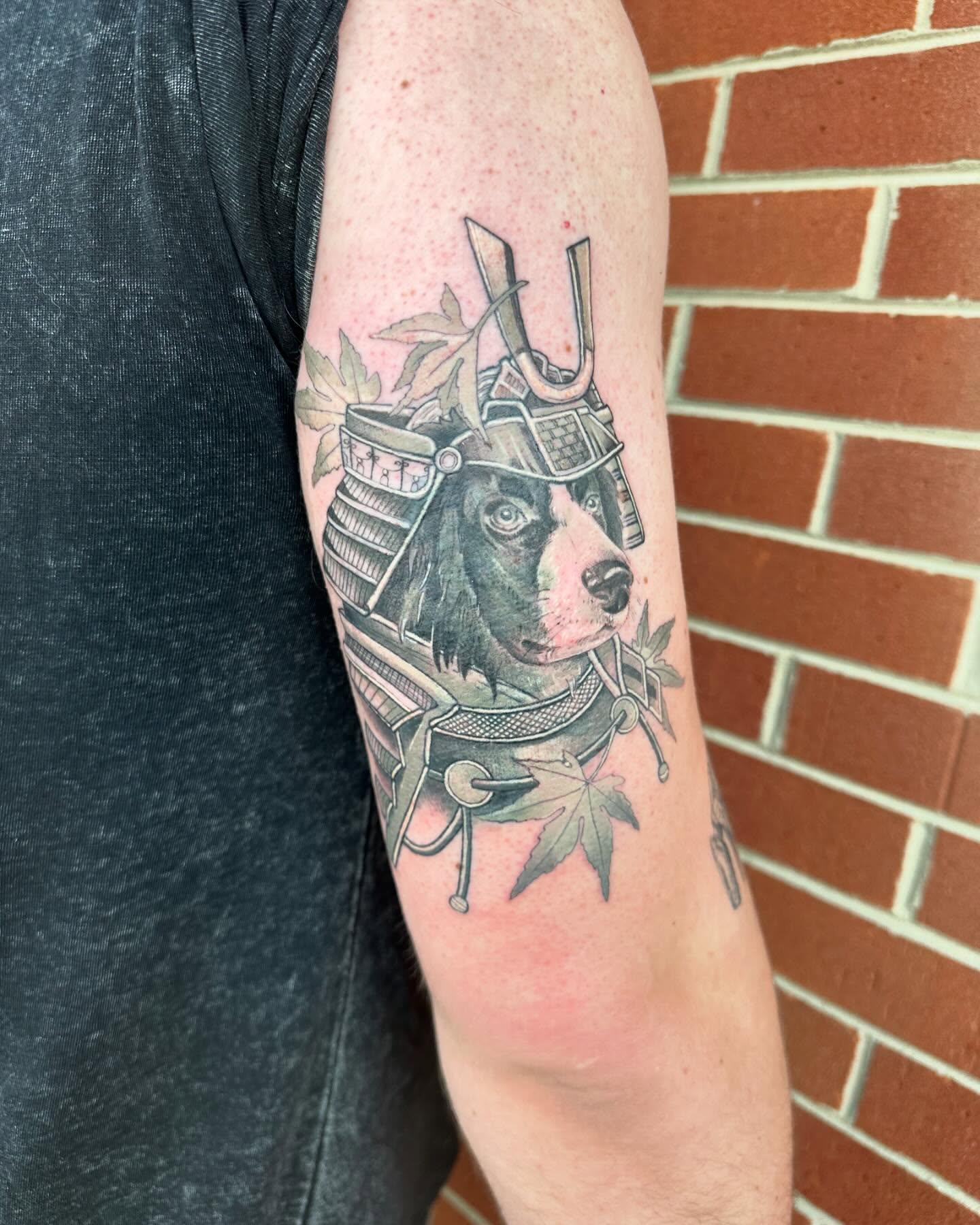 Dog wearing samurai armor realism tattoo on the forearm by Cassandra Rasper-Beard