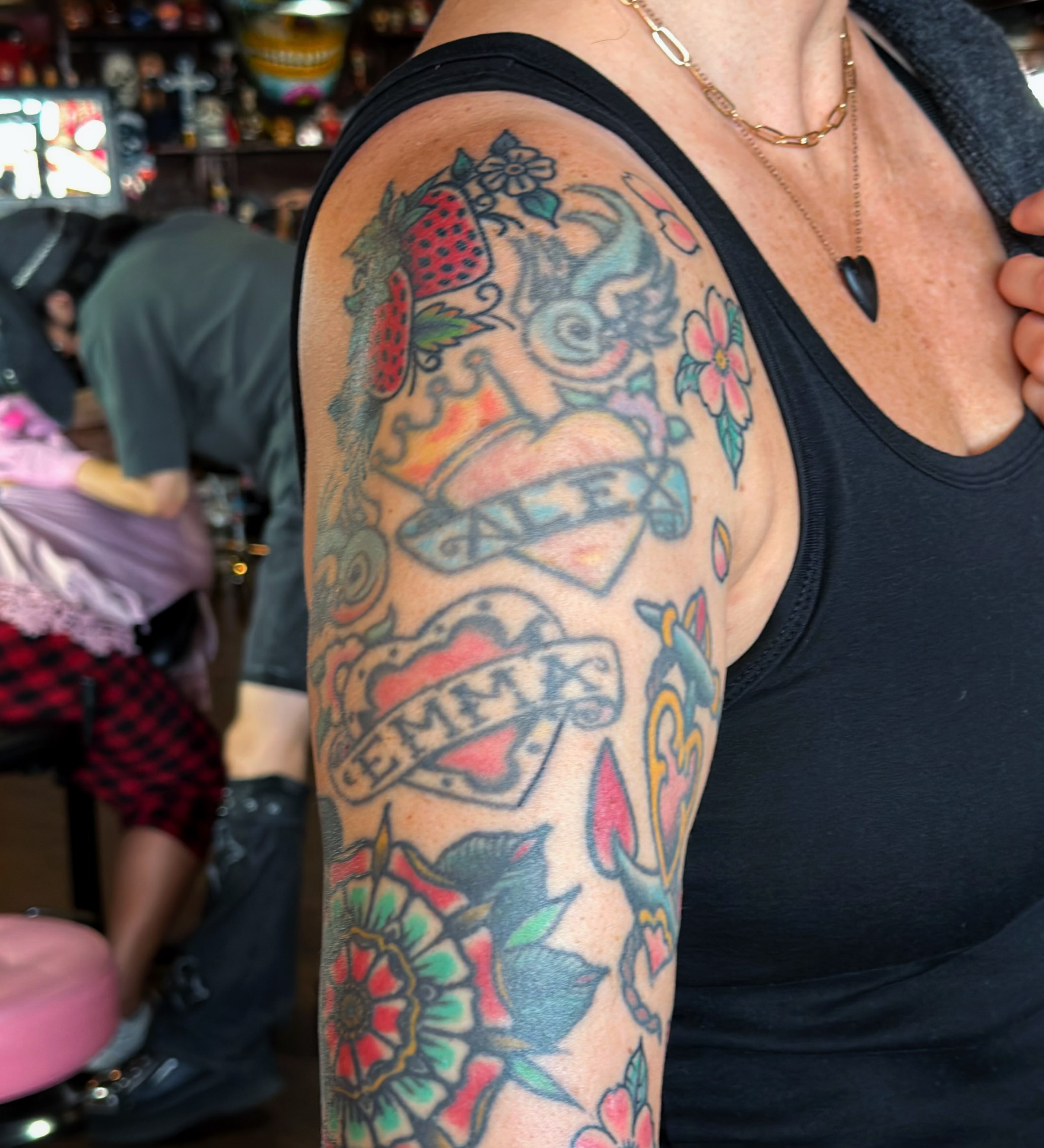Floral and fruit design American traditional tattoo on the upper arm by @sloanxkettering