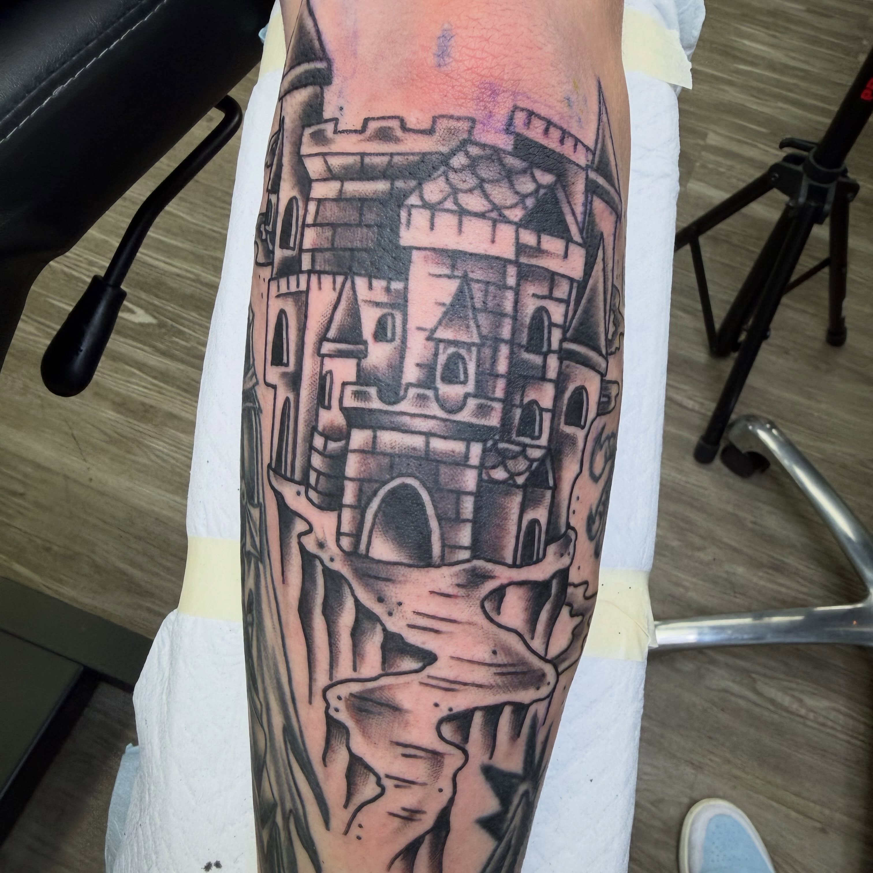 Castle black and grey tattoo on the forearm by Amy Kolton