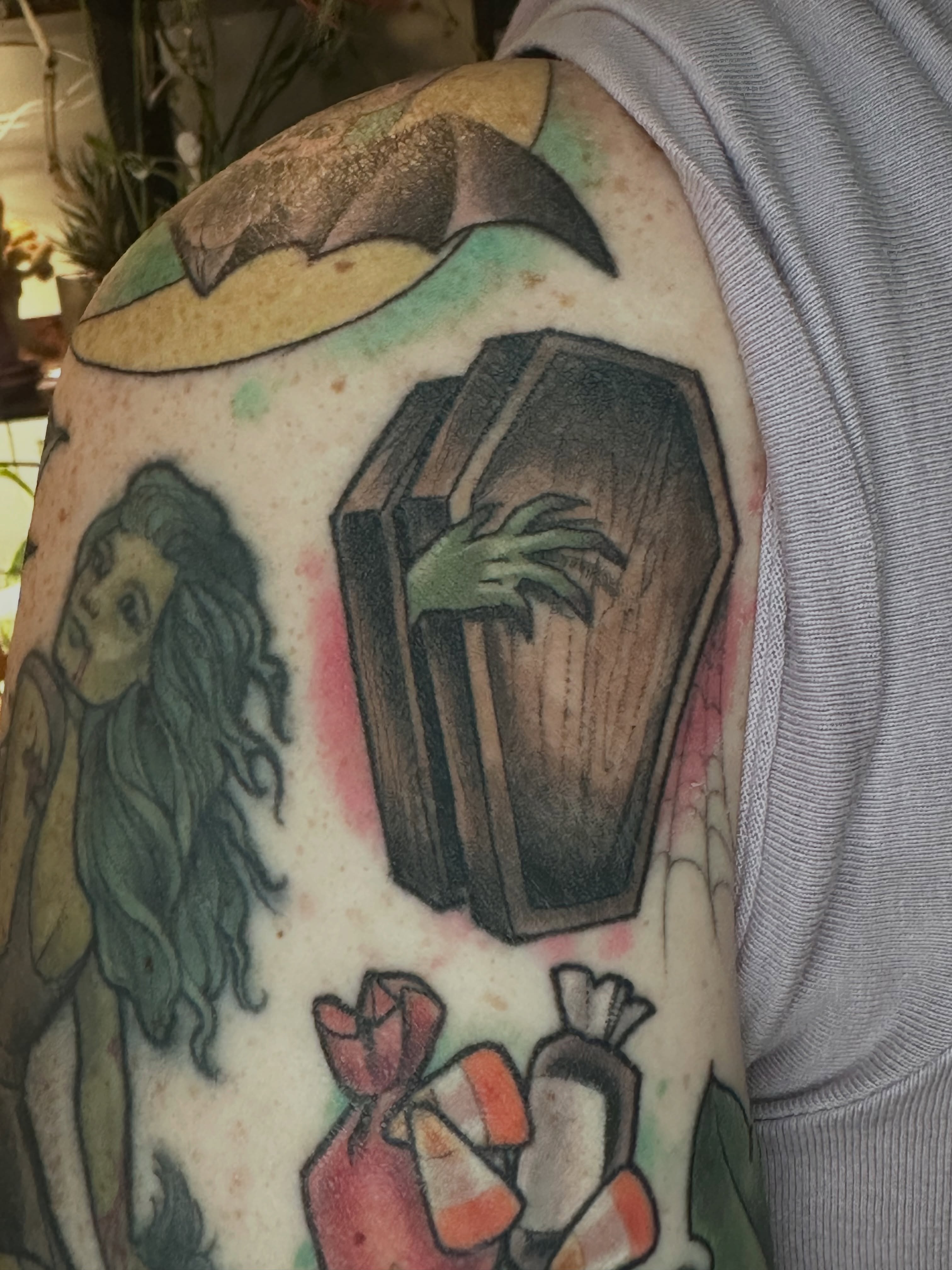 Casket and zombie hand realism tattoo on the upper arm by Katie Hutchins, Dayton, Ohio