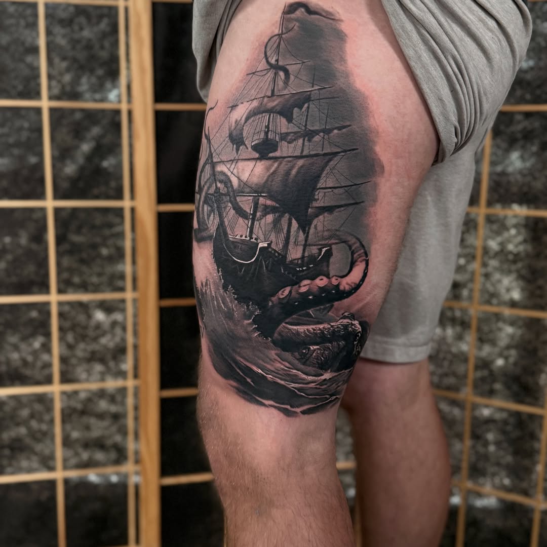 Ship and octopus realism tattoo on the thigh by Miles Haysmith