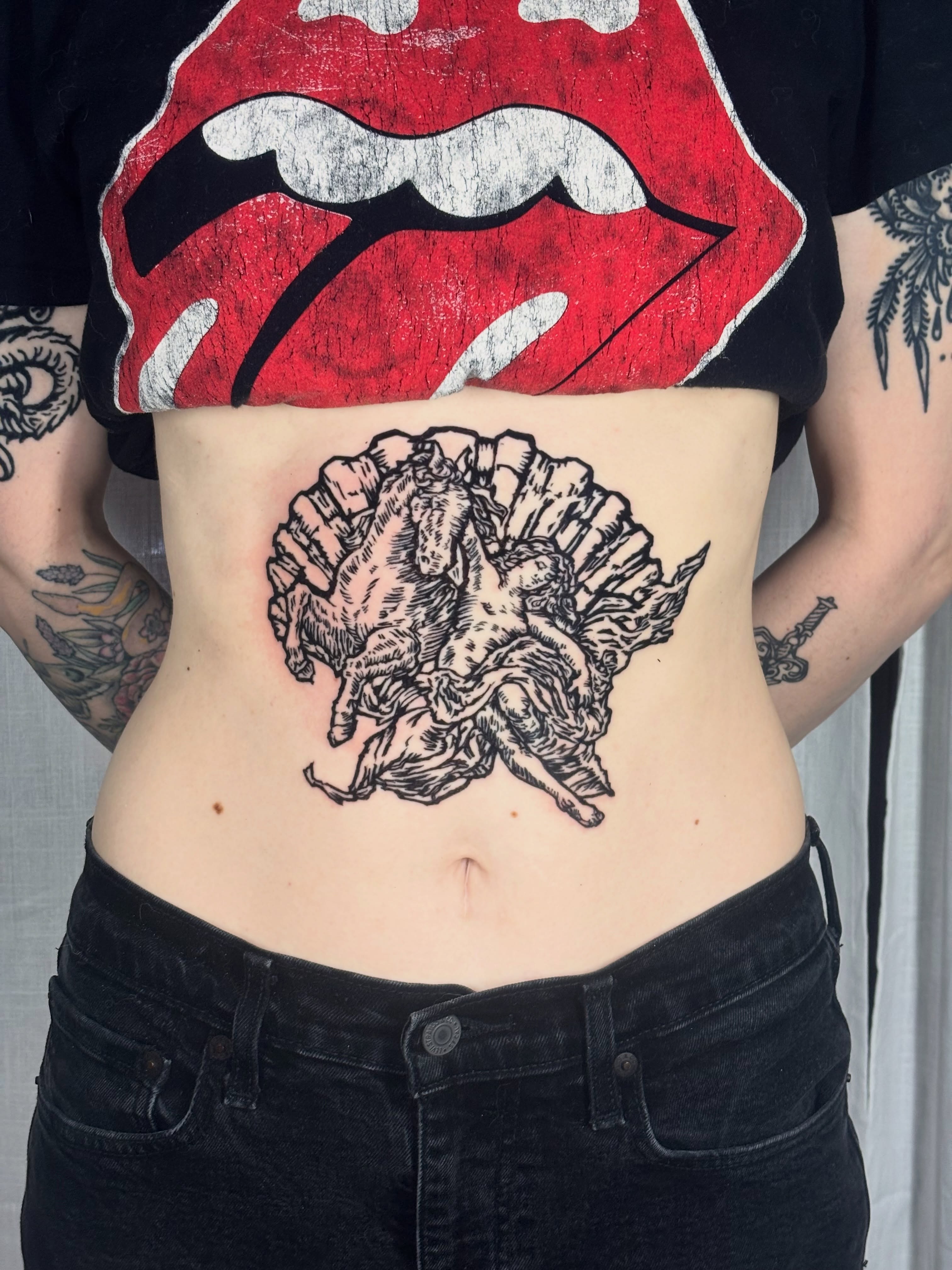 Horse and rider black and grey tattoo on the torso by Wren Cavanaugh Tattoos, Seattle, Washington