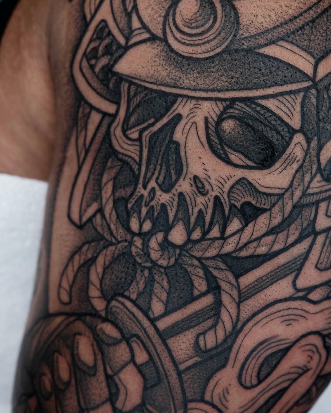 Skull with helmet geometric tattoo on the forearm by Kyle Patrick